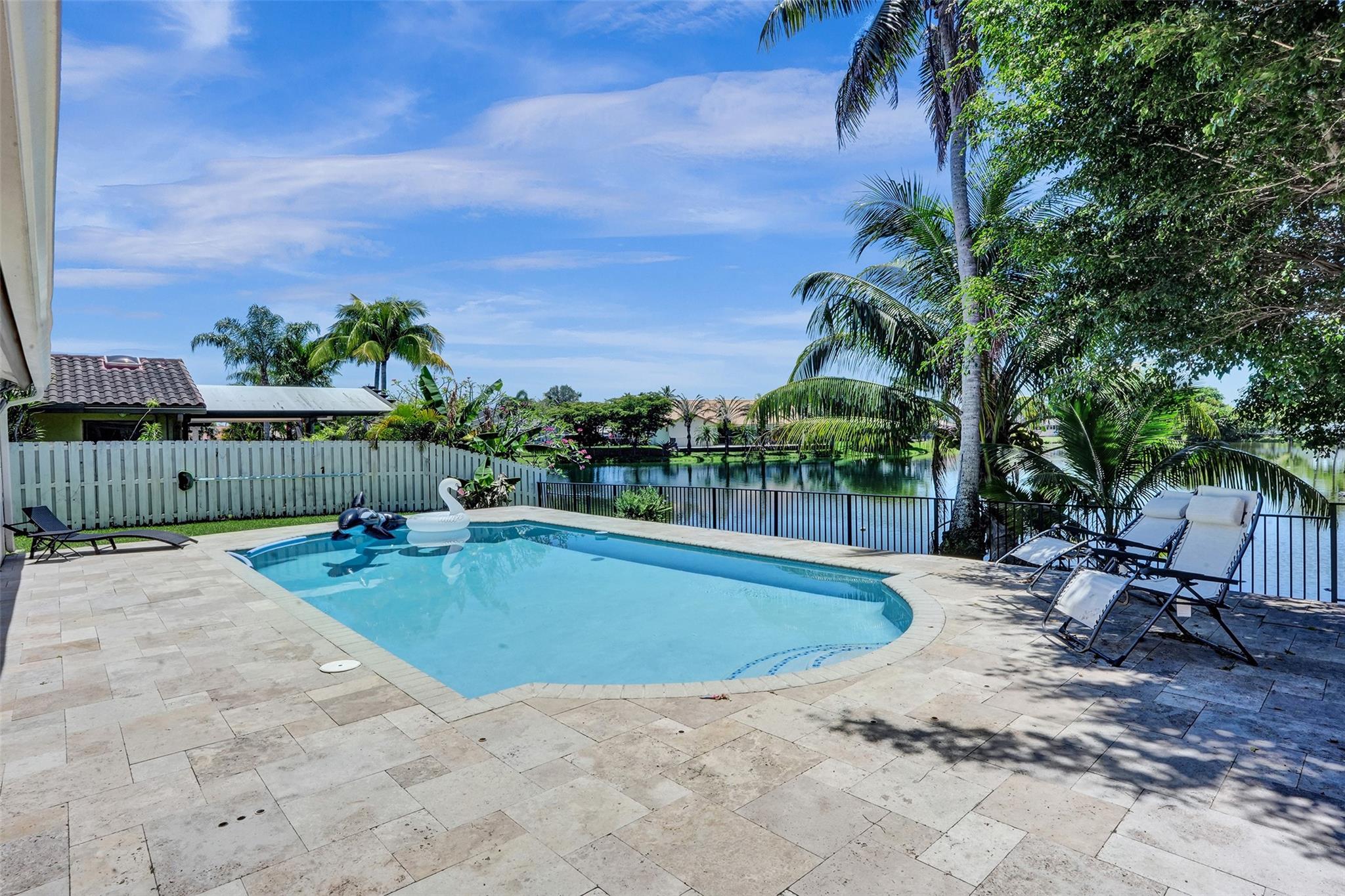 STUNNING LAKEVIEW HOME FEATURING 5 BEDROOMS, A DEN, AND 3 FULL BATHROOMS, LOCATED IN THE SOUGHT-AFTER COMMUNITY OF JACARANDA LAKES, KNOWN FOR ITS FRIENDLY NEIGHBORS AND SERENE ENVIRONMENT. ENJOY OUTDOOR LIVING WITH A HEATED POOL, NEW PAVERS, UPGRADED DIAMOND BRITE AND TILE. RECENT UPGRADES INCLUDE BRAND-NEW IMPACT WINDOWS (2023) ALONG WITH A NEWLY INSTALLED FENCE. THE ROOF WAS REPLACED IN 2015. THE HOME OFFERS TWO A/C UNITS—ONE INSTALLED IN 2023, AND A WATER HEATER IN 2021. THERE IS A HUGE LIVING ROOM THAT IS CURRENTLY USED AS A PLAYGROUND AND CAN BE MADE AS A 6TH BEDROOM. SITUATED IN A TOP-RATED ELEMENTARY SCHOOL DISTRICT AND CONVENIENTLY CLOSE TO PARKS, SHOPPING CENTERS, AND MORE. THIS HOME BLENDS COMFORT, CONVENIENCE, AND LOCATION—A TRUE GEM YOU WON’T WANT TO MISS!