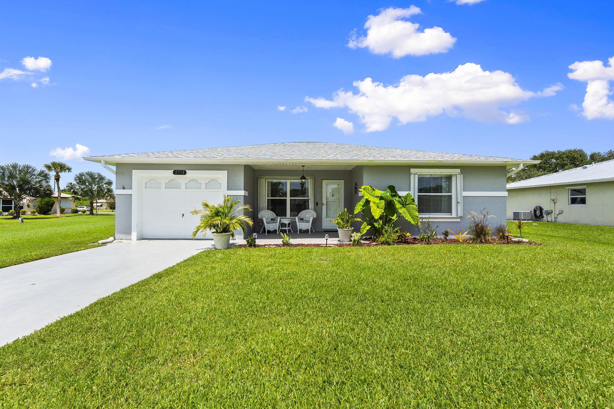 Located on end of a cul-de-sac, this property has no neighbors on 1 side giving you plenty of room to landscape, privacy & parking. Full accordion shutters & concrete block construction= secure & safe. Roof & gutters replaced 2020. Well kept w/ features like luxury vinyl plank floors, updated light fixtures/fans, recessed lighting, pendant lights, retractable shades in the Florida room & convenient island in the kitchen offers additional storage. Palm Grove has an active social calendar, plenty of events to keep you entertained. Enjoy the lakeside, year round, heated pool, tennis, bocce, billiards & so much more. 24 hour manned security gate. Just a few minutes drive to all that Ft Pierce and Port St Lucie have to offer. Low, county only taxes! HOA fee includes everything except electric!
