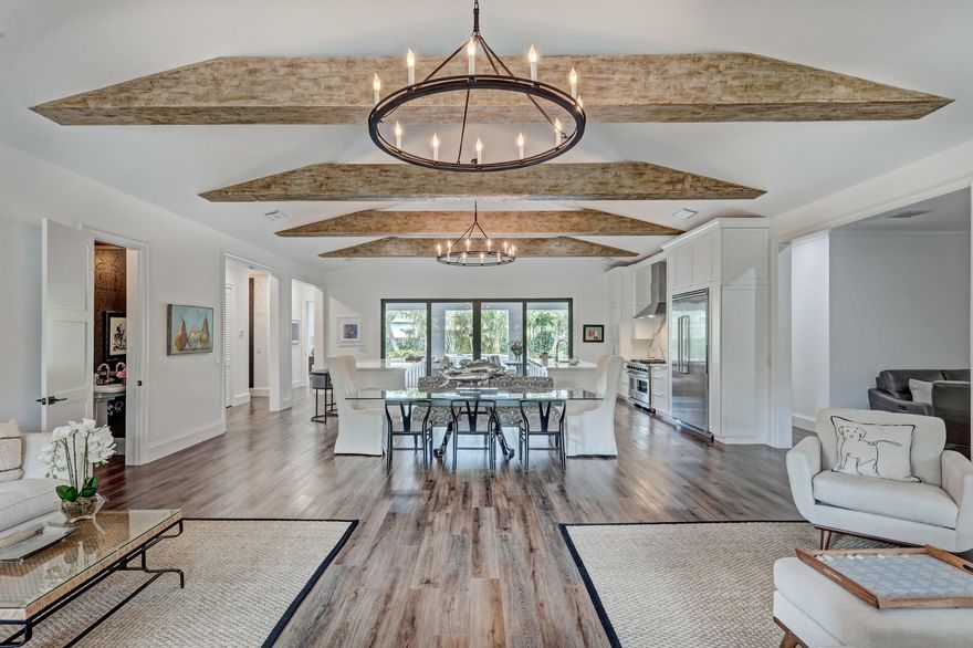 This 3 bedroom/4.5 Bath single story 4,900 SF beauty is nestled on a lushly landscaped 15,000 SF lot.  It boasts a cook's dream double-island kitchen, a grand living/dining room with soaring ceilings, and a custom wine room with cooler and many more features. This home features a smartly laid out split floor plan. It has an enormously gracious master bedroom suite on one side with his/her baths, sitting area, and a custom closet that would satisfy even the  most discerning. The other side of the home houses two beautifully welcoming guests suites, a den (4th bed option), and a huge laundry room. Beyond the impeccable living spaces, you will find a 500 SF covered loggia with a gas grill and dining area plus a pool area fit for even your pickiest guests.