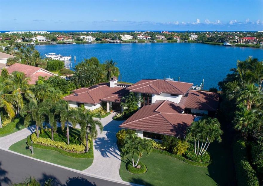 Prestigious Location! Stunning Design! Captivating View! 121' on the harbor waterfront & deepwater dock. This 5 bed, 5 ½ bath retreat exudes casual elegance. The use of cool neutrals in the travertine paver driveway, the Crema Marfil floors of the main living area & the oyster shell patio, creates harmony & flow. Natural light plays off warm wooden ceilings in the living & family rooms & highlights the beauty of exotic marbles & stones. The kitchen is outfitted with granite, Wolf range, Subzero, prep island & custom pantry. Entertaining is a breeze with 2 separate interior spaces, each with their own fireplace and bar, and a fabulous covered lanai with outdoor grill, heated pool with waterfall spa. Home completely and exquisitely renovated in 2016. LIKE NEW AND GORGEOUS!