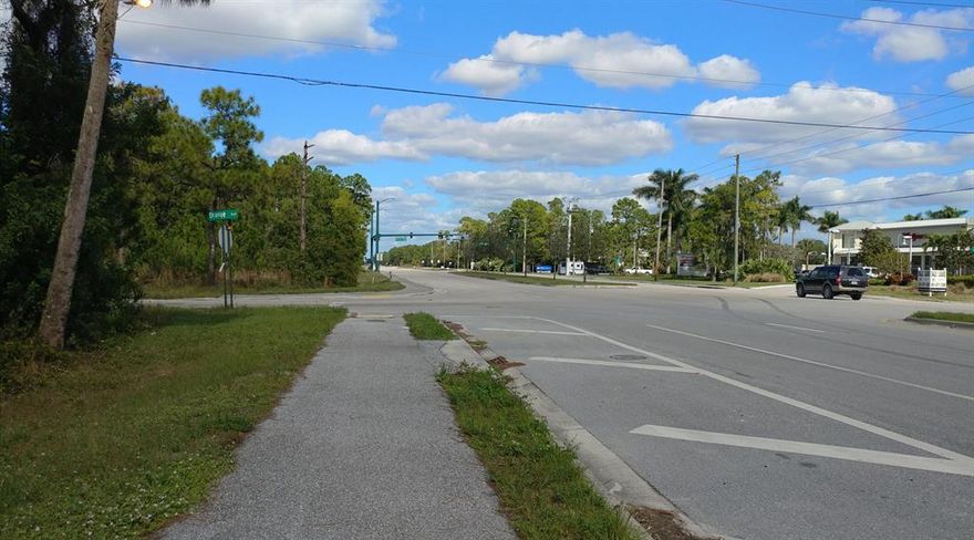 OUTSTANDING INVESTMENT OPPORTUNITY! Possibilities are endless! 1.67 acre lot on the SW corner of 2 major high traffic roads: Seminole Pratt Whitney and Orange Blvd. Across street from  Walgreen's Store and the Publix Shopping Plaza in the Acreage.  Some pine trees and palmetto vegetation.