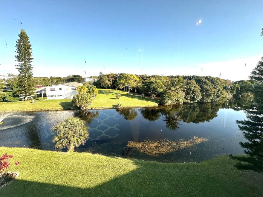 GORGEOUS WATER VIEW highlight this IMMACULATE 2 bedrm, 1.5 bath 4th flr condo. The updated galley kit features granite cntrs, tile backsplash & over-cabinet ltg. This spotless unit offers tile flrs thru-out & is being sold FULLY FURNISHED. Addt'l upgrades incl a new electrical panel & renovated bathrms. The primary bath boasts a walk-in shower w/glass shower doors. Encl patio w/IMPACT GLASS sliding windows, offering an unobstructed water view. The bldg has a new roof & new elevators providing added value and peace of mind. A truly move-in-ready home with exceptional views. Enjoy RESORT STYLE LIVING in this active adult gated community w/24 hr security, pools, tennis, pickleball, cafe, shuffleboard & an AMAZING CLUBHOUSE w/endless amenities! DON'T MISS THIS ONE! ASSOC. CLAIMS 55+