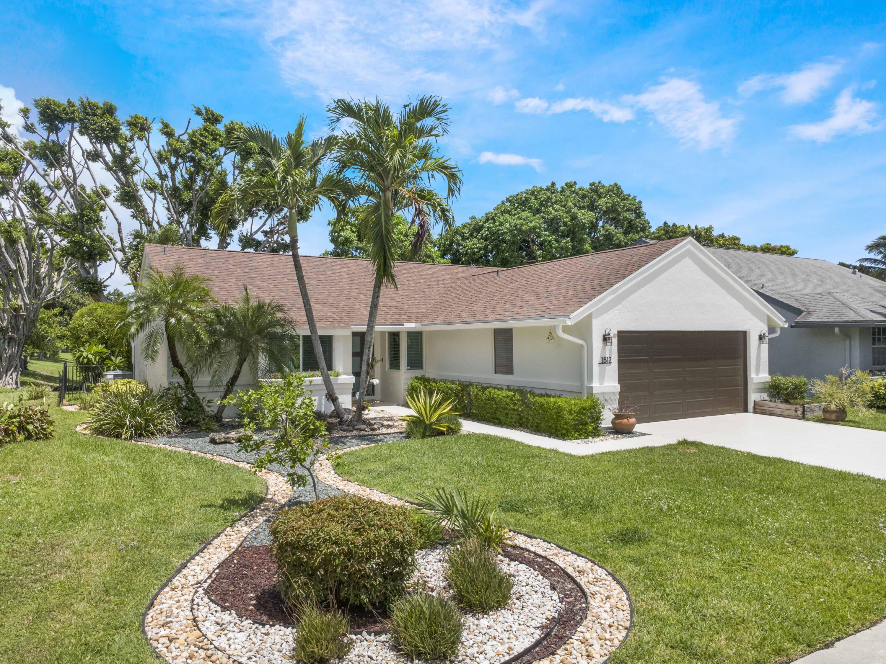 Welcome to this centrally located gated community with easy access to I-95 and the turnpike. Close to shopping and restaurants. The property boasts a newly painted exterior, new roof, new impact windows, new HVAC, new water heater and lush landscaping. The open floor plan, with updated cabinetry and appliances, offers a fantastic lakeview with plenty of natural light. This three bedroom, two bath, two car garage property is move in ready. Enjoy the back patio with long lake views that is fully fenced in and ready for entertaining.