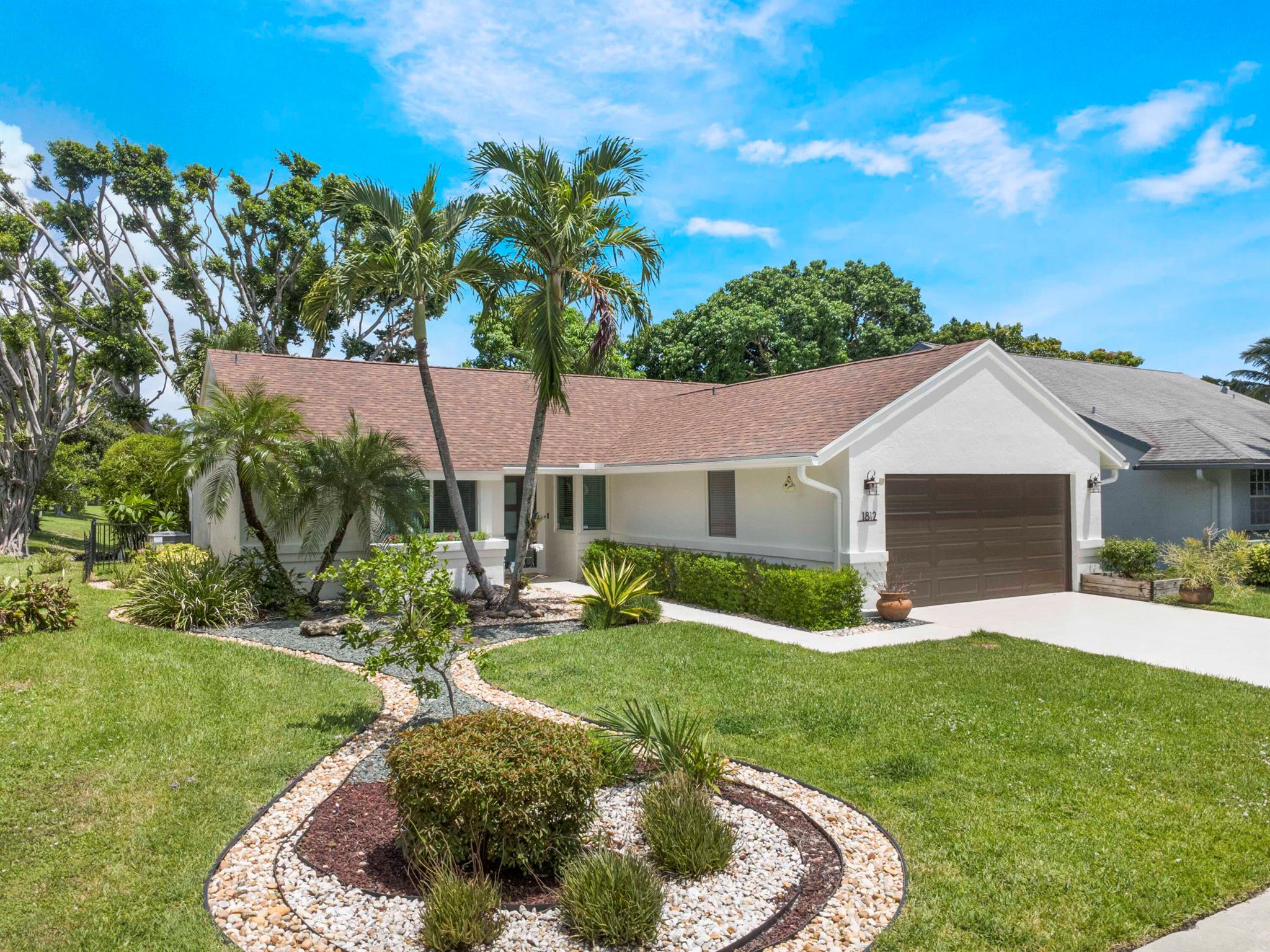Welcome to this centrally located gated community with easy access to I-95 and the turnpike. Close to shopping and restaurants. The property boasts a newly painted exterior, new roof, new impact windows, new HVAC, new water heater and lush landscaping. The open floor plan, with updated cabinetry and appliances, offers a fantastic lakeview with plenty of natural light. This three bedroom, two bath, two car garage property is move in ready. Enjoy the back patio with long lake views that is fully fenced in and ready for entertaining.