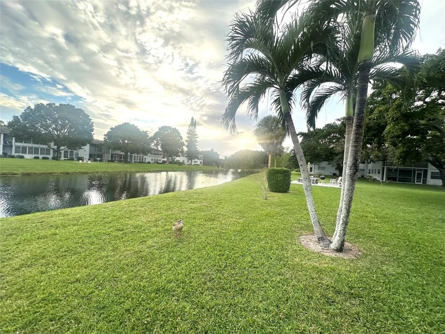 JUST REDUCED! Enjoy easy living in this charming 1-bedrm, 1-bath condo w/a beautiful CANAL VIEW located in a desirable Deerfield Bch active adult community. Unfurnished & ready for your personal touches, this 2nd fl unit features lam flrs in the dining area & kit, w/cozy carpet in liv rm & bedroom. The kit incl a new white refrigerator. Primary bath has a convenient tub/shower combo. Relax on encl patio w/plantation shutters & W/W A/C while taking in tranquil canal-view sunsets. Courtyard-style bldg loc near East gate & close to shopping, dining & min to Beach! Gated & 24 hr sec, Century Village offers amenities galore incl. pools, tennis, pickleball, putting green, Clubhouse w/cafe, clubs, classes, gym, billiards, movies, shows & more! DON'T MISS THIS GREAT OPPORTUNITY! Assoc. Claims 55+