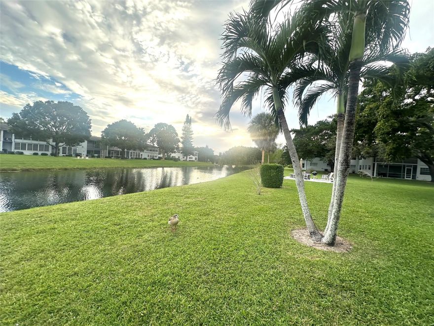 Enjoy easy living in this charming 1-bedrm, 1-bath condo w/a beautiful CANAL VIEW located in a desirable Deerfield Beach active adult community. Unfurnished & ready for your personal touches, this 2nd fl unit features lam flrs in the din area & kit, w/cozy carpet in liv rm & bedroom. The kit incl a new white refrigerator. Primary bath offers a convenient tub/shower combo. Relax on enclosed patio w/plantation shutters & W/W A/C while taking in tranquil canal-view sunsets. Courtyard-style bldg loc near East gate & close to shopping, dining & min to the Beach! Gated & 24 hr sec, Century Village offers amenities galore incl. pools, tennis, pickleball, putting green, Clubhouse w/cafe, clubs, classes, gym, billiards, movies, bdwy shows & more! DON'T MISS THIS GREAT OPPORTUNITY! Assoc. Claims 55+