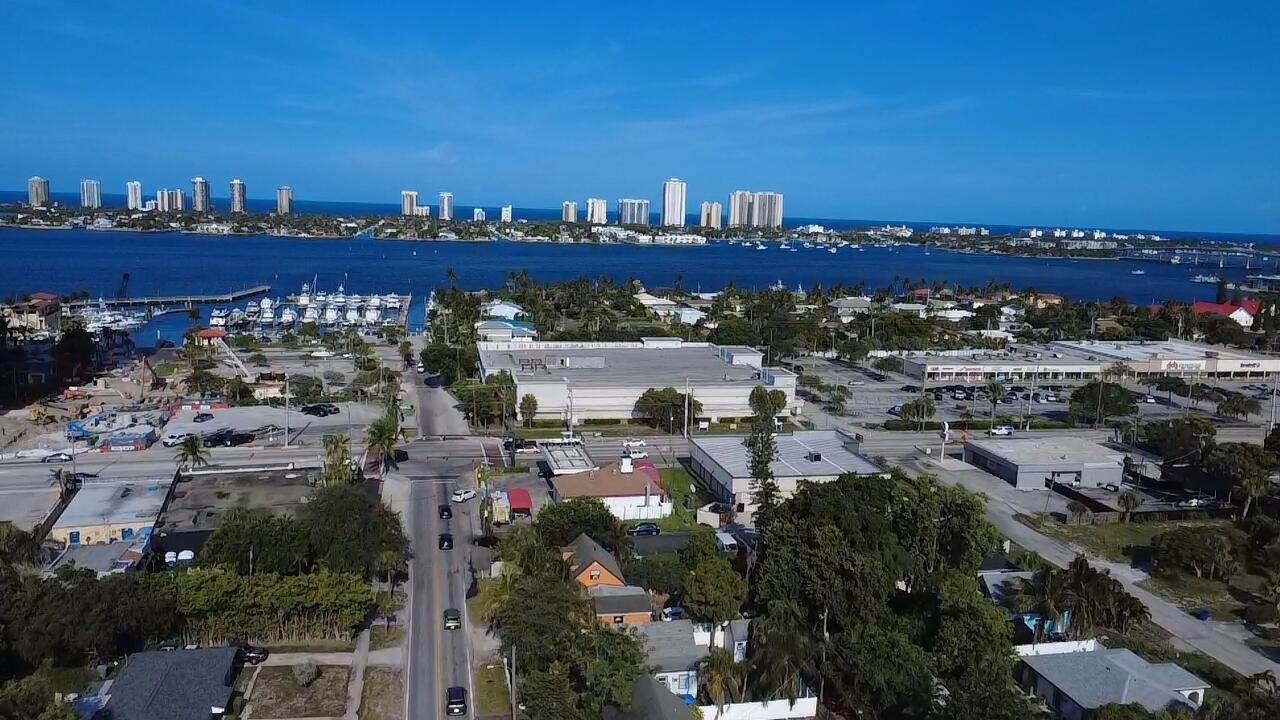 No HOA! Easy application process. Bring your water toys - there is a dock and marina just down the street! This beautifully updated, spotless 3-bedroom, 2-bath home is minutes from Singer Island, beaches, shops, restaurants, and world-class sailfishing and diving. The backyard features new pavers and palm trees for a peaceful outdoor space. Two bedrooms and a full bath are on the main level, plus a spacious upstairs suite with its own bath and a versatile loft for office or den. Large, fully fenced yard with a double gate for boat or RV parking. Electric, water, lawn care, and pest control included. Full-impact windows and doors plus a private laundry room with full-size washer/dryer.