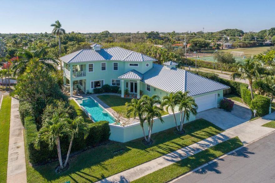 Stunning custom built home in the Southend, east of Olive and just a short distance to the Intracoastal Waterway. Designed to enjoy South Florida living at its best! Great for entertaining, indoor living flows seamlessly to the gorgeous outdoors. Covered porches and beautiful pool with fountains all surrounded by privacy wall. High ceilings, bamboo floors, open floor plan, hurricane impact windows & doors, formal dining room with tray ceiling and gorgeous kitchen. Custom cabinetry, Caesar stone counters, double ovens, 6 burner gas stove, 2 sinks, large pantry and plenty of counter seating.  2 large bedrooms downstairs. Master suite upsatirs plus den or 4th bedroom. Luxurious master bath, double vanity, tub and separate shower.  Huge closets, lots of storage, over sized garage & generator!
