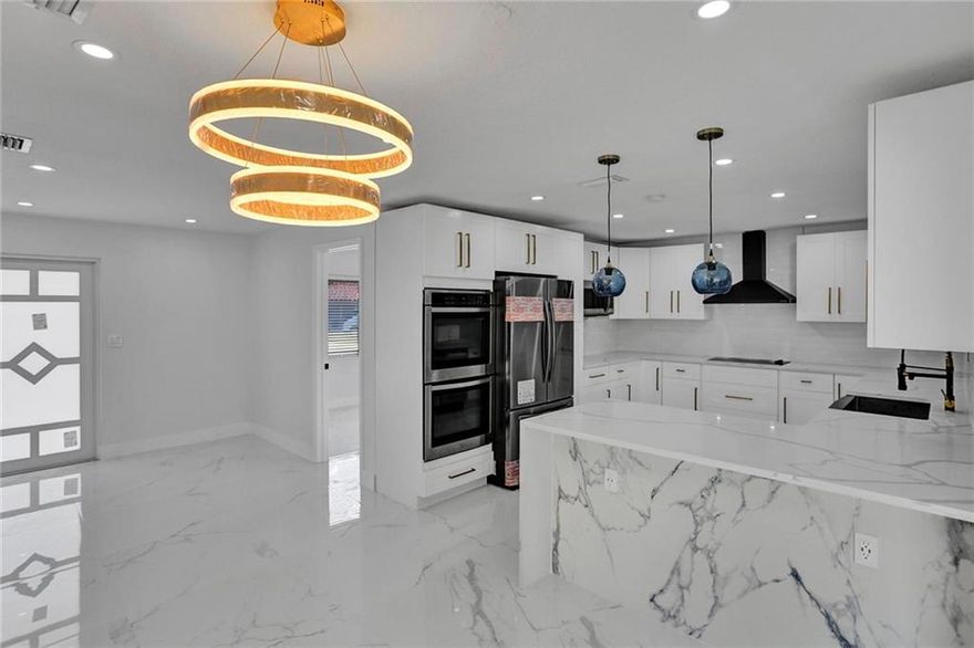 Completely remodeled 3 BDR/2 BTH home in Hollywood. Features new roof (2022), all new Impact Windows & drs. New AC, all new electrical & panel. Gigantic new Kitchen with Qtz cntps, new S/S appliances, cooktop, dble oven, pantry. BTHs remolded with porcelain tile, frameless shower drs & new vanities & toilets. New textured  walls/ceiling, new recessed lights entire house. New window treatment. Accent walls with fireplace. Has bonus room that is setup as a family rm can be converted to 4th bdr.  New tankless water htr. New 32X32 porcelain tiled floors, freshly painted in & out. HUGE corner lot, with new alum. fence, brand new circular paved driveway (can fit up to 10 cars), newly placed SOD. This is a real GEM!!! minutes away from Hardrock Stadium, No HOA. Will not last! YOU MUST SEE IT! Completely remodeled 3 BDR/2 BTH home in Hollywood. Features new roof (2022), all new Impact Windows & drs. New AC, all new electrical & panel. Gigantic new Kitchen with Qtz cntps, new S/S appliances, cooktop, dble oven, pantry. Will not last!