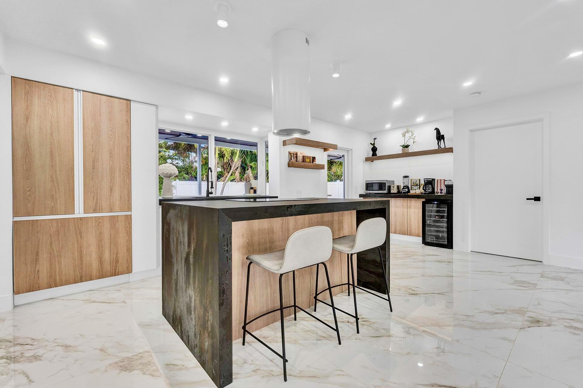 Immediate equity, Appraised at 2.4 million, renovated home offers a perfect blend of modern luxury & coastal charm, just steps from the beach! Every detail has been thoughtfully designed, with high-quality finishes throughout, including sleek flooring, custom cabinetry, & elegant fixtures. The open-concept invites natural light, creating a bright and airy space ideal for relaxing or entertaining. The gourmet kitchen features top-of-the-line appliances, a large island, & ample storage, seamlessly connecting to the spacious living & dining areas. Outdoors, the professionally landscaped yard is an entertainer's dream, boasting lush greenery, a large patio, pool & plenty of space for hosting friends & family. Whether hosting a BBQ or enjoying the ocean breeze, this home is your private retrea