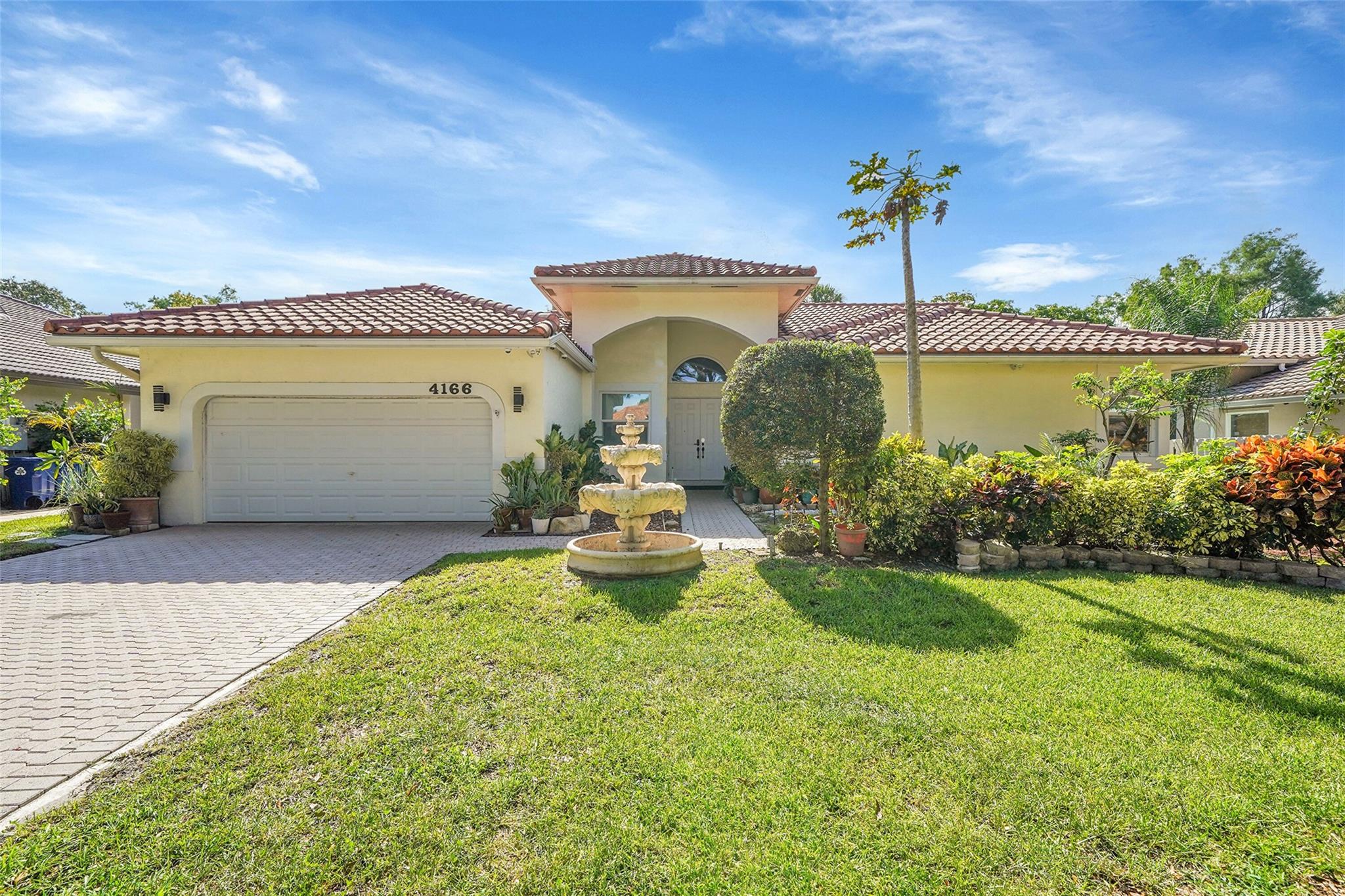 This beautiful home offers an ideal blend of style and durability! Major updates include a 2018 roof and water heater, along with high-impact windows and doors for enhanced security. Inside, the heart of the home is its sleek European-style kitchen, boasting gorgeous, one-of-a-kind quartzite countertops and backsplash, plus stainless steel Samsung appliances. Modern vinyl flooring and recessed lighting flow throughout. Parking is a breeze with an expansive driveway and a 2-car garage featuring durable epoxy flooring. A unique bonus: the oversized second bedroom offers potential to be converted into a fourth bedroom, providing flexible living options. Discover tranquility in the botanical backyard, your private outdoor sanctuary.