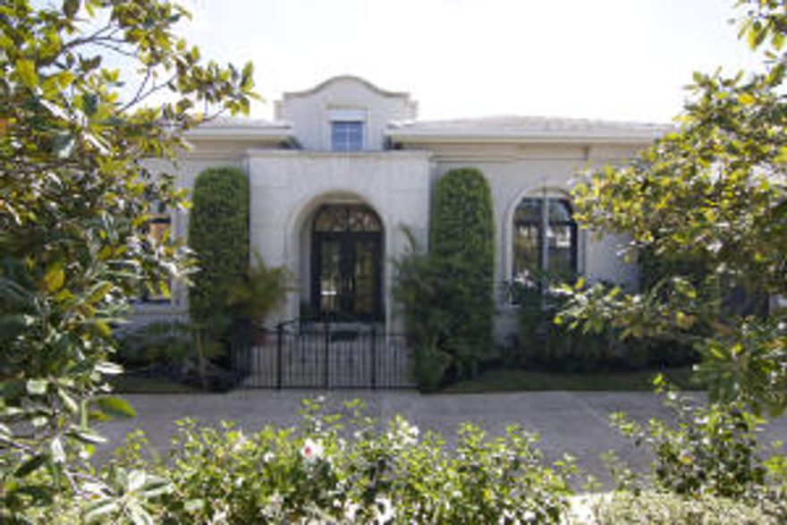 Contemporary mid-town location, on the ocean block, With over 3200 sq. ft. of living space. 3 bedrooms, plus a library-den, 3 1/2 baths, with a 2 car garage. An impressive entry into the great room, with 13 ft. ceilings, and 22 ft. of retractable glass pocket doors overlooking the pool deck. Travertine marble floors throughout the living areas, triple crown molding, and a covered loggia off  the living room, make a great entertaining space. Light and bright, with a large open floor plan. Contemporary white kitchen has abundant counter space, with a breakfast room, and pantry. The library is completely finished in burled oak walls, and shelving. All doors and windows are protected by an