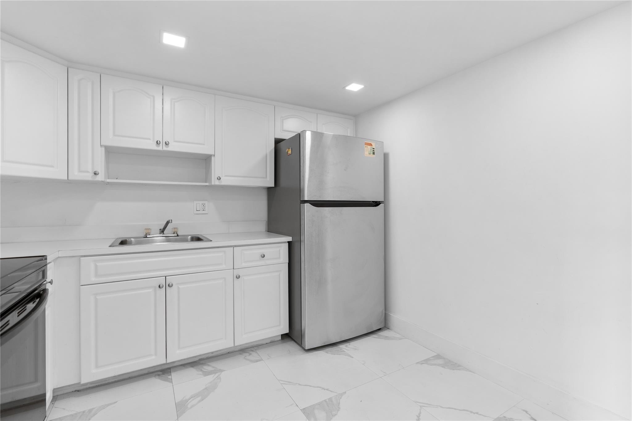 ALL AGES WELCOME! Beautifully updated condo in the desirable gated community of the Manors at Inverrary. This spacious 2-bedroom, 2-bath home features an open-concept layout with stylish porcelain tile flooring throughout, a open kitchen with stainless steel appliances, and a split-bedroom floorplan offering optimal privacy. Features include in-unit laundry, central A/C, ceiling fans, and assigned parking. The building has a new roof and completed 40-year certification, giving you peace of mind for years to come. This turnkey unit is perfect for first-time buyers, downsizers, or investors looking for a great opportunity in a thriving community! Minimum credit score 650 and $40,000 for single owner or $60,000 household income.