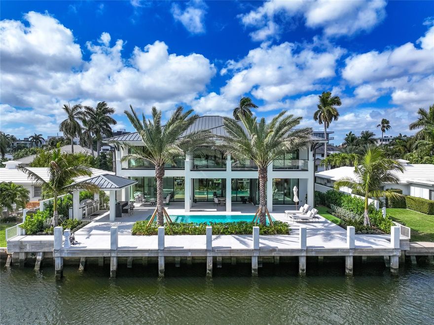 A masterpiece of bespoke craftsmanship, 144 Fiesta Way is a newly built Bermuda-inspired residence in Fort Lauderdale’s exclusive Las Olas Isles. Custom designed with the highest standards, this 6,200sf waterfront home boasts 85 feet of deep-water frontage. Venetian plaster walls, soaring ceilings, touches of copper, and a fossil stone water vapor fireplace define the interiors. The gourmet kitchen dazzles with Sub-Zero, Wolf, and Cove appliances, while five ensuite bedrooms showcase custom vanities, Waterworks fixtures, and Versace tile showers. A Crestron system, custom-built offices, a four-car garage, and a heated saltwater pool elevate luxury living. Additionally, there is a whole-house generator and water filtration system. This residence is ready for the discerning buyer.