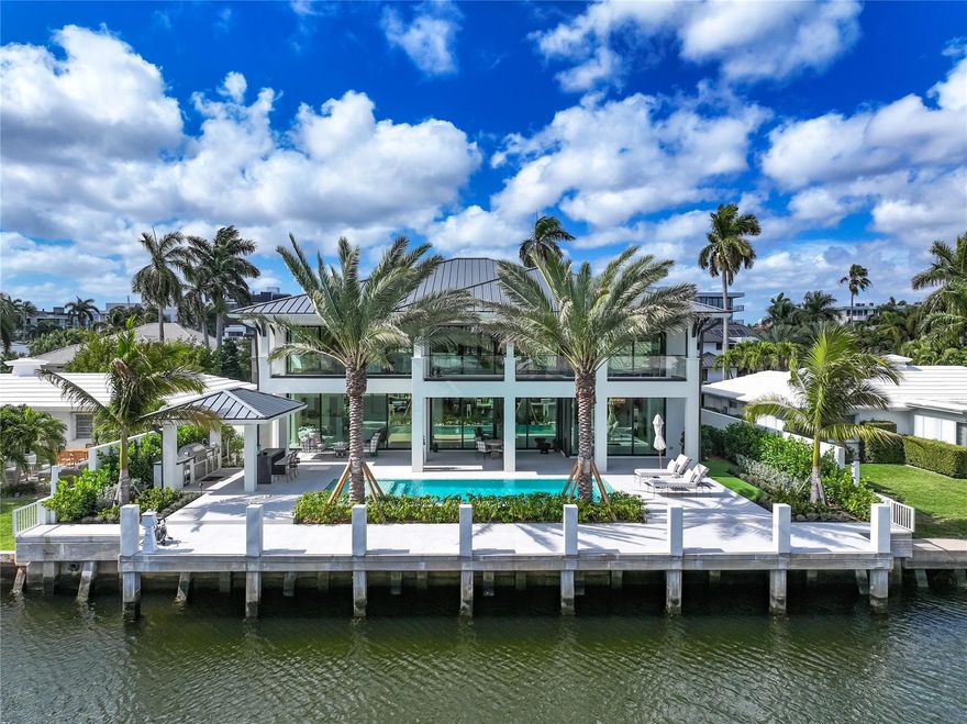 A masterpiece of bespoke craftsmanship, 144 Fiesta Way is a newly built Bermuda-inspired residence in Fort Lauderdale’s exclusive Las Olas Isles. Custom designed with the highest standards, this 6,200sf waterfront home boasts 85 feet of deep-water frontage. Venetian plaster walls, soaring ceilings, touches of copper, and a fossil stone water vapor fireplace define the interiors. The gourmet kitchen dazzles with Sub-Zero, Wolf, and Cove appliances, while five ensuite bedrooms showcase custom vanities, Waterworks fixtures, and Versace tile showers. A Crestron system, custom-built offices, a four-car garage, and a heated saltwater pool elevate luxury living. Additionally, there is a whole-house generator and water filtration system. This residence is ready for the discerning buyer.