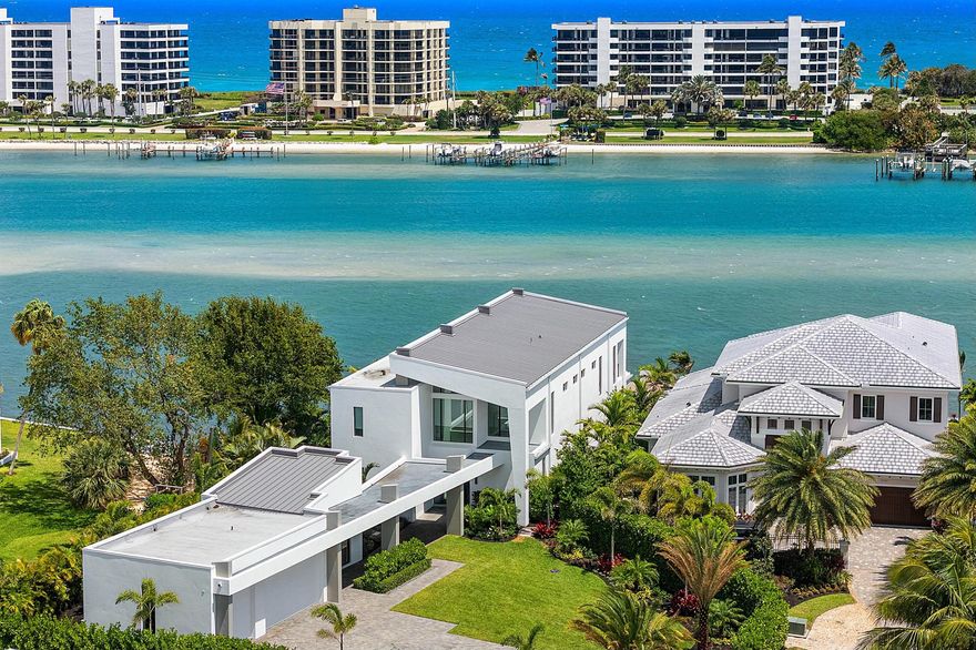 This breathtaking modern estate, built in 2022 by Rothrock Construction, boasts 180 feet of Intracoastal frontage with stunning blue-water views. Situated on a private 0.5-acre lot with no HOA, it offers sleek architecture, expansive glass walls, soaring ceilings, and high-end finishes. The open-concept design features a gourmet kitchen with a gas stove, while a separate guest house provides additional privacy for visitors. The Seller has upgraded all the landscaping for enhanced beauty and seclusion, adding premium artificial turf throughout the backyard for a lush, low-maintenance appeal. The fire pit has been upgraded to a sleek linear design, perfect for entertaining or relaxing. Priced to sell, this waterfront masterpiece is a rare opportunity!