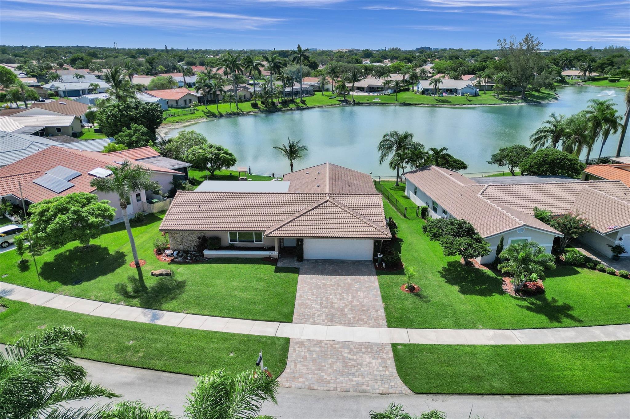 Lakefront living at its best! This 3-bed, 2-bath home sits on a peaceful lake with wildlife views and stunning sunsets right in your backyard. Enjoy the water from your covered, screened-in patio perfect for relaxing year-round. The home has a split floor plan, vaulted ceilings, and plenty of natural light. The kitchen offers extra cabinet space & a buffet area, while both bathrooms have been tastefully updated. The spacious primary bedroom includes a large closet. Pride of ownership shows throughout—from the well-kept landscaping & freshly painted garage floor to the impact windows and sliders for added storm protection. The irrigation system pulls water from the lake, helping save on utility bills. Low HOA of just $175 per year. Close to Centennial Park & downtown Coral Springs.