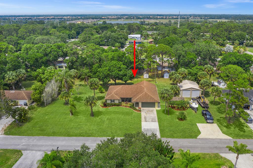 Stretch out with all your toys sitting on almost 3 lots(over 1/2 acre), with no strict HOA, and detached 26x30 2 bay garage with 220 60 volt amp power! This spacious 4/2 open-concept with split-plan home feat new water system & 2017 tankless water heater! Great proximity to I-95 for quick travel and the famous Ft Pierce inlet/jetty to enjoy the boat! Rm szes aprx