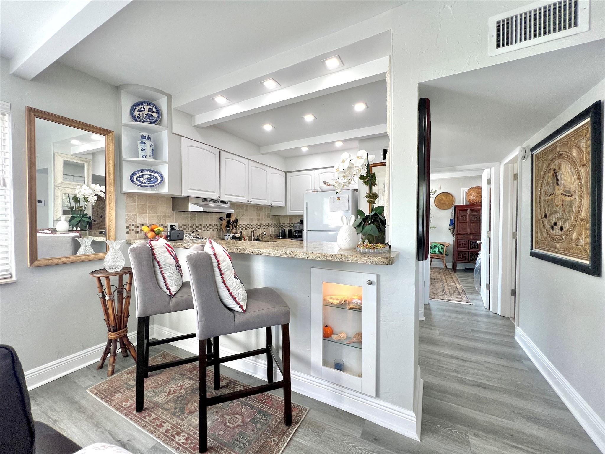 Fantastic opportunity to own a charming one-bedroom, one-bathroom unit in a boutique, Key West-style community, just half a block from the vibrant restaurants, shops, and entertainment on Wilton Drive. This second-floor corner unit features an updated interior with a semi-private patio just outside your door, impact windows and doors, abundant natural light, and a view of the pool area from the living room. With vinyl floors throughout, a heated pool, and BBQ area, the beautifully landscaped and well-maintained grounds make this the perfect place to call home. Pet-friendly (under 20 pounds, with approval), with laundry and additional storage on-site. One assigned parking spot. Tenant occupied until November 1.