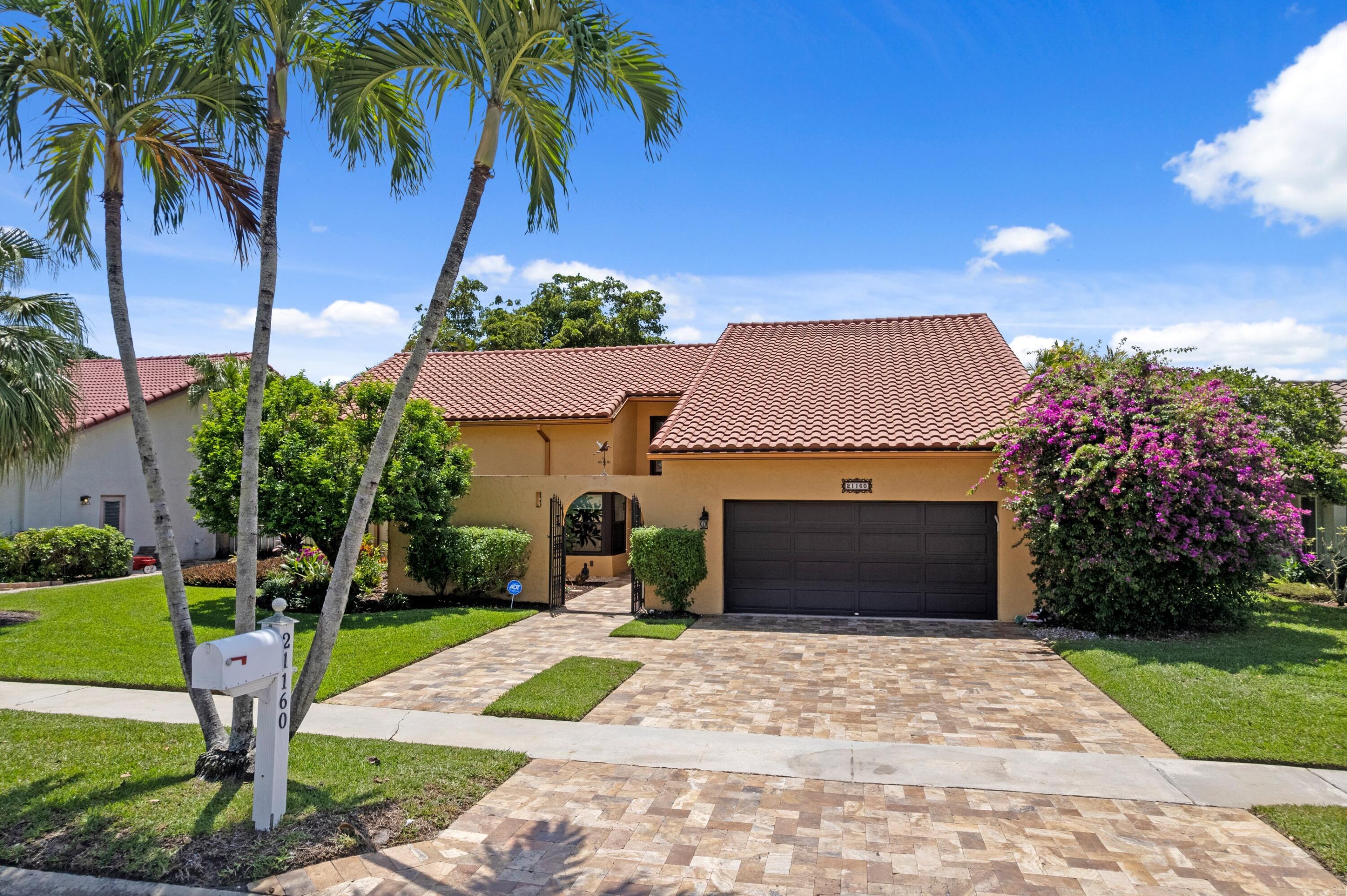 BEAUTIFUL WATERFRONT HOME WITH BREATHTAKING LAKE VIEWS | 24 HR Manned Gated Community | Hurricane impact windows & doors | Lush landscaping | Bright open floor plan with lake views from almost every room | Wood burning stone fireplace | Skylights and vaulted ceilings with recessed LED lighting | Remodeled kitchen with quartz countertops, S/S appliances, plentiful cabinets and large pantry | Custom closets in all 3 bedrooms | Remodeled bathrooms with dual vanities and marble countertops | Screened patio & additional outdoor paver patio with incredible lake views | 2 car garage with wall storage system | Travertine paver driveway and walkway | Roof 2016 | Low HOA fee| Great Boca location with top rated schools | Close to shopping, restaurants, highways, and Boca attractions