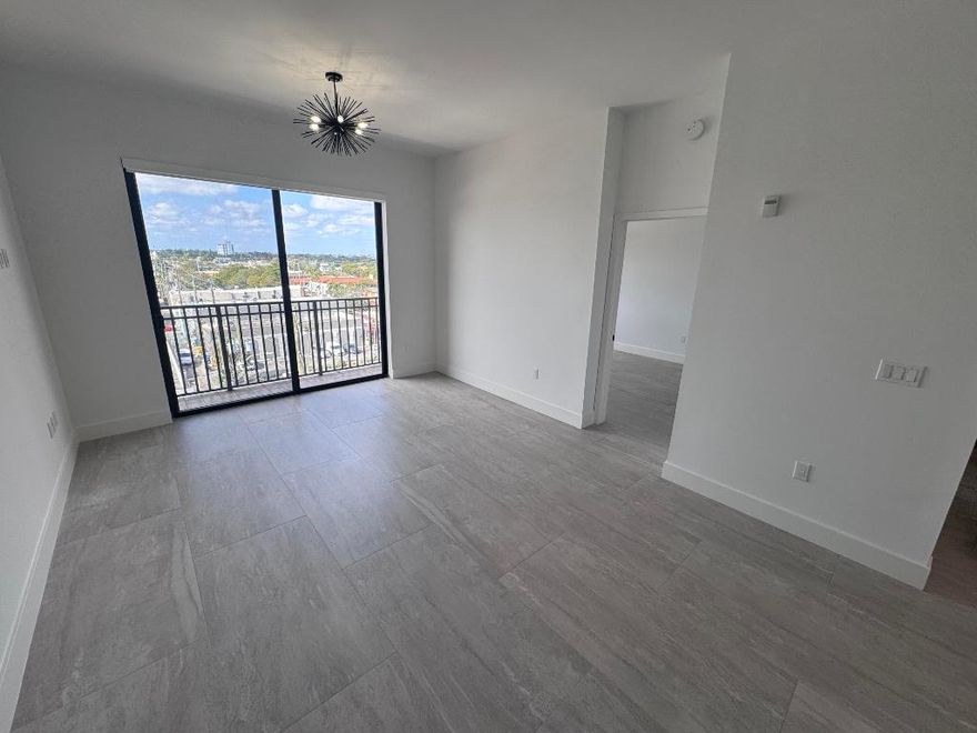 Step into luxury with this beautifully renovated, interior penthouse designed to impress. Enjoy soaring volume ceilings, elegant tile flooring throughout, and a sleek white kitchen featuring quartz countertops and stainless appliances. Unwind in the spa-inspired bathroom, complete with a separate soaking tub and shower, plus a stylish hanging cabinet. For added convenience, the unit includes a washer and dryer. Water and basic cable are included. Located in the heart of downtown Lake Worth Beach, you'll be just steps from vibrant dining, shops, parks, golf, and entertainment, and less than a mile from the beach. The building offers a fitness center and a stunning rooftop pool, along with an assigned covered garage parking space and additional street parking. Come take a look today.