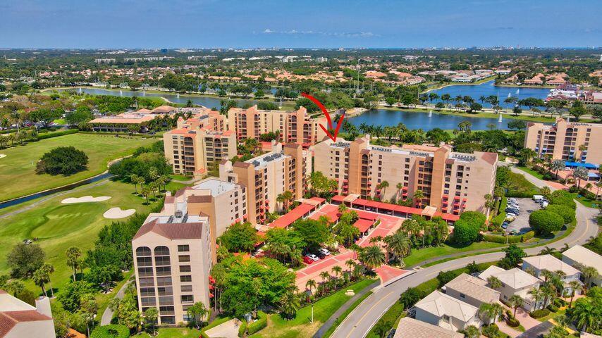 Spacious 3BR/2.5BA condo in the Promenade with the community's largest floor plan! Enjoy tropical garden views from the oversized enclosed terrace, just steps from the clubhouse and pool. Features include wood & laminate floors, smooth ceilings, and a versatile den/3rd bedroom with Murphy bed. The eat-in kitchen offers granite counters, wood cabinetry, stainless steel appliances, walk-in pantry, and pull-out drawers. Primary suite has 2 walk-in closets and an updated bath with dual sinks, vanity, soaking tub & separate shower. Upgrades include newer appliances, 2 ACs, brand-new water heater, updated baths, and laundry with utility sink. Two assigned parking spaces, extra storage, and recent building updates complete this must-see home!