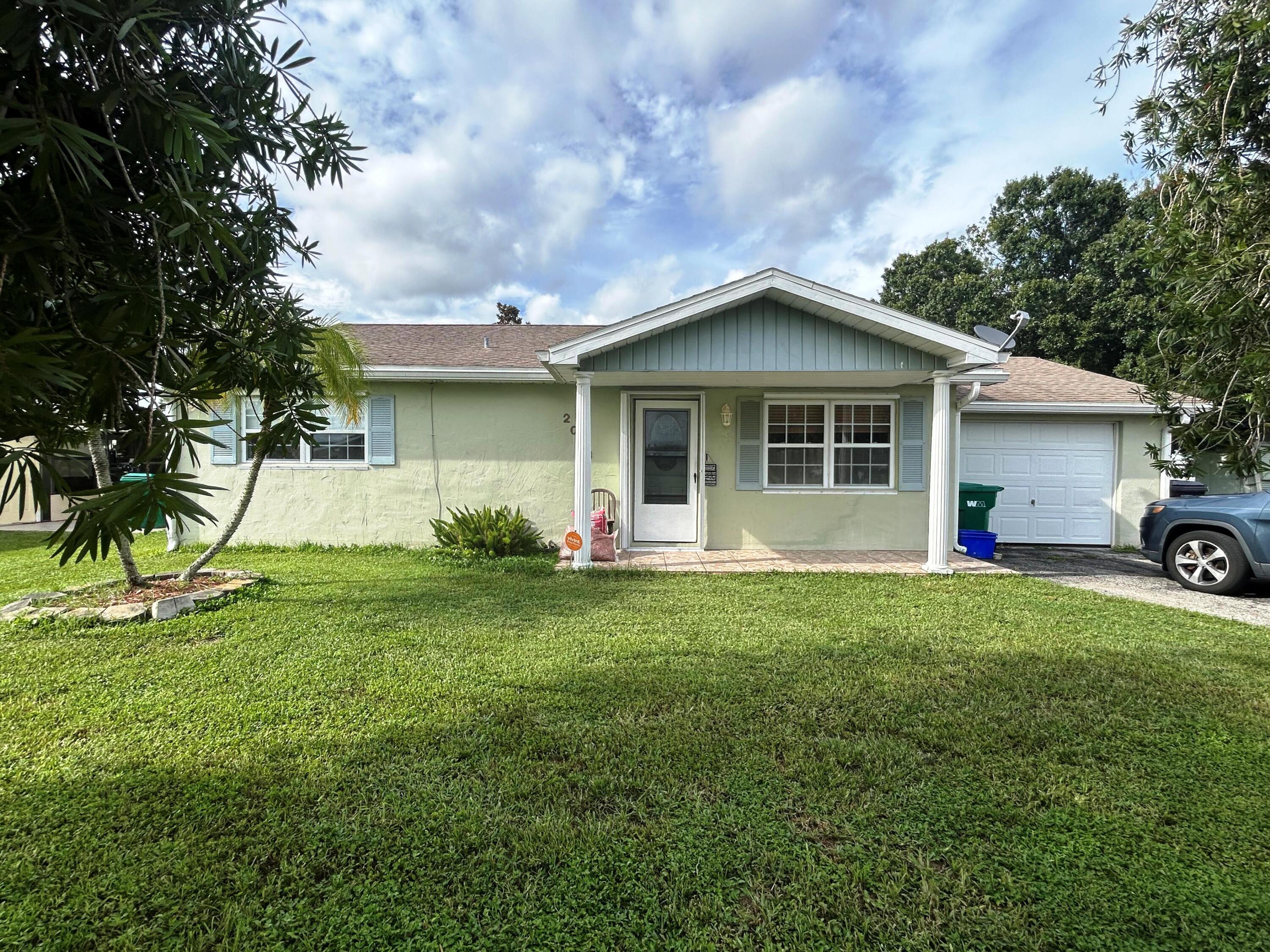 Fisherman's Special!!! Charming CBS construction 2/2 home in a quiet neighborhood on a Lake Access Canal in Okeechobee. Located within 5 minutes of the locks, this property includes a seawall and dock with running water and electricity. NO HOA!!! New roof in 2017, A/C in 2022, Dishwasher in 2024, Garbage Disposal in 2023 and new laminate flooring in 2025. home has a smart security system and complete hurricane protection (accordion shutters for front door and back patio (making it usable during a storm) and panels for the remainder of the home).