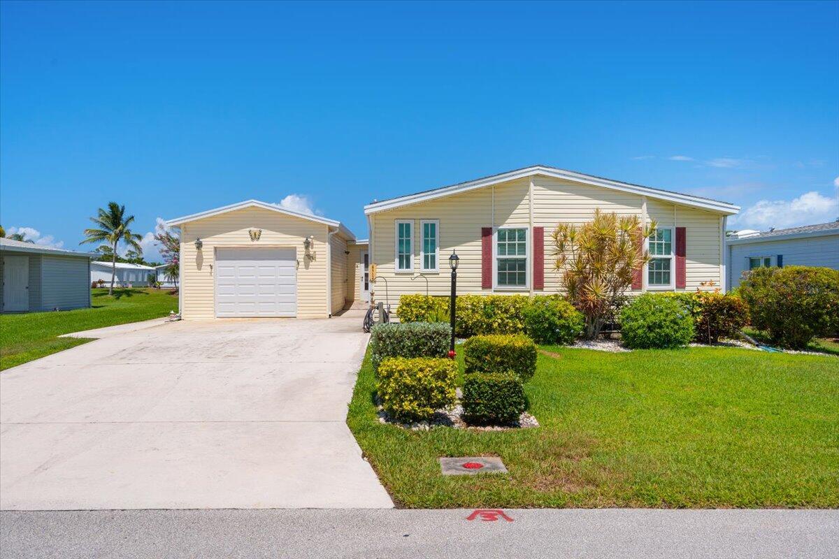 LAND OWNED ON THE WATER. OVERSIZED GARAGE. HURRICANE IMPACT WINDOW .PLANTATION SHUTTER THROUGHTOUT THE INSIDE OF HOME. NEW ROOF. UP GRADED A/C TWO BEDROOM . TWO FULL BATHROOMS DON'T MISS THIS ONE. LAND OWNED.PAY ONLY HOA. NO LAND LEASE. CABLE & INTERNET & SEWER INCLUDED IN HOA. AMMENITIES INCLUDING PRO SHOP. 18 HOLE GOLF COURSE . THREE CLUBHOUSES. THREE POOLS HEATED, PICKLE BALL, TENNIS, STATE OF THE ART EXCERCISE ROOMS, SHUFFLE BOARD, BOCCE BALL, HORSESHOES RV AND BOAT STORAGE ON SITE.