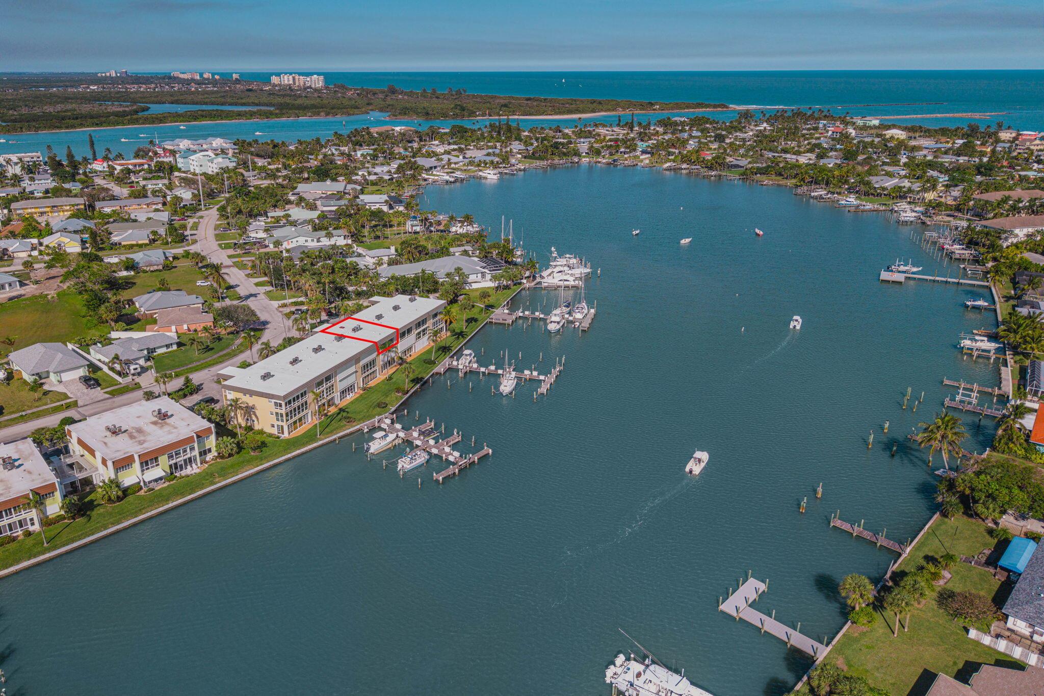 Enjoy Spectacular Intercoastal & Marina views from this Penthouse unit. Million $$ Thumb Point homes can be seen from the BEST building in this 55+ complex, says the owner. Additional event space + waterfront deck at the end of this building, makes it easy for owners to participate. Docks are owned by the association w/low monthly rental fees, therefore its ideal for Boat Owners to have their vessel in view, a BOATER'S DELIGHT. Sellers have maintained their condo w/these improvements: Kitchen w/granite counters, wood cabinets, some stainless appliances including range w/air fryer. Tile floors throughout + impact windows on FL RM that serves as their dining area & electric shutters for storm protection. The building had been totally rebuilt after the 2004 storms therefore newer electrical