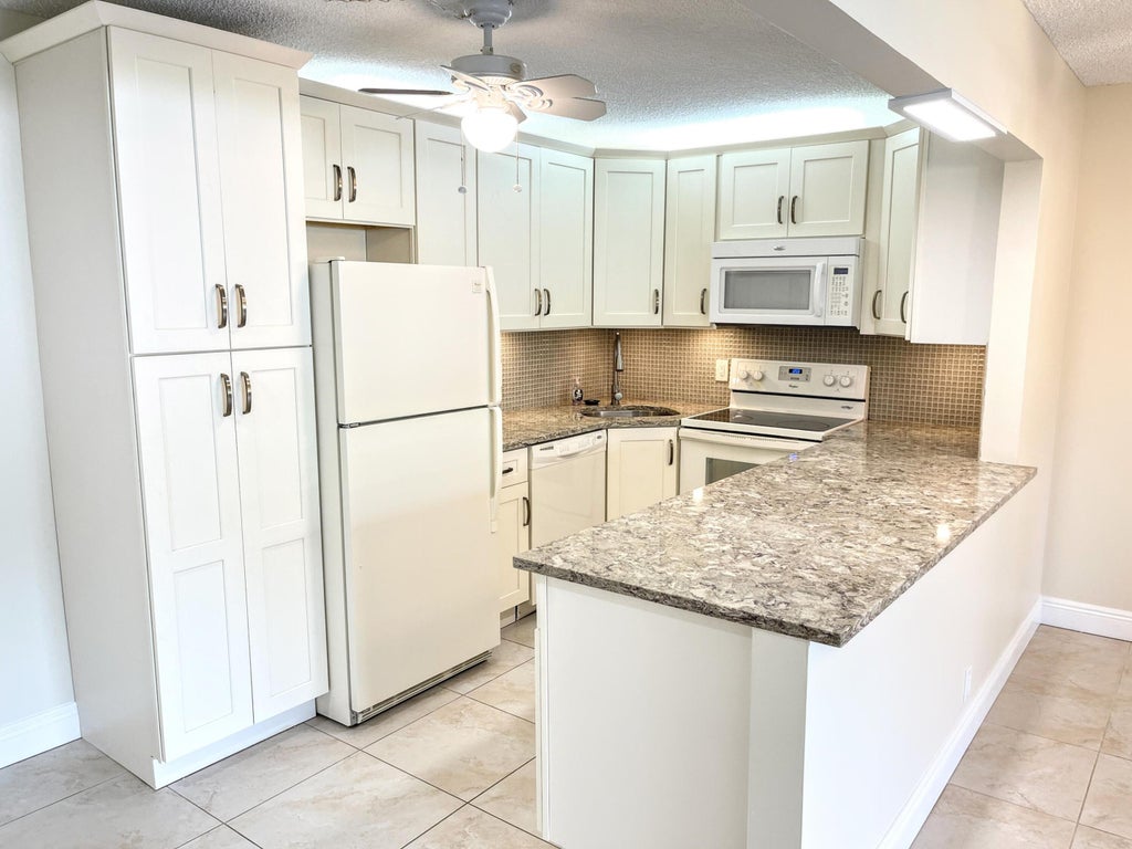 Photo of 801 Sky Pine Way #F1, Greenacres, FL 33415 (MLS # R10974545)
