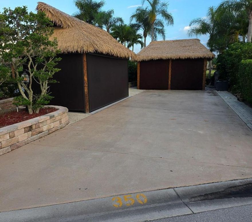 The right stuff!  Large well appointed lake/pond front lot with waterfall views!  2 tikis with synthetic, low maintenance palm frond roofs with automatic shades with internet operation. Tile floors enhance the beauty of the tikis! Gorgeous high end well appointed kitchen, stainless appliances, weather resistant cabinets and granite counters.  Custom canvas covers for all for off season protection! Additional paver seating entertainment spaces.  This is a smart priced, must see lot.  Furniture and TV are excluded.  Motorcoach Resort St Lucie West is a gated Class A Motorcoach resort with amenities galore including an 18 hole executive golf course, 4 pools, hot tub, pickleball, tennis, and so much more!  Dog friendly, second to none activities and on site management.  More photos to come.