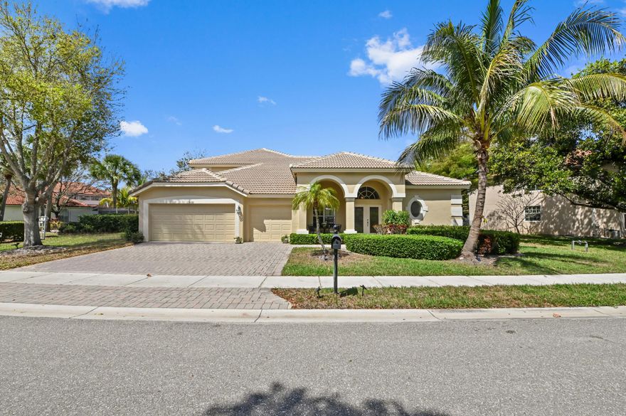 Discover coastal elegance in the heart of West Palm Beach at 3638 E Hamilton Ky. This stunning 5-bedroom, 4-bathroom pool & waterfront residence is nestled within the prestigious gated community of Hamilton Bay, offering a lifestyle of luxury and tranquility. BRAND NEW ROOF!!! From the moment you arrive, the Mediterranean-inspired architecture, manicured hedges, and arched entryway set a tone of sophisticated charm. Inside, the home unfolds into a light-filled sanctuary defined by soaring vaulted ceilings and expansive windows that frame picturesque views of the private pool and the shimmering lake beyond.   The heart of this home is a masterfully designed living space, where the kitchen seamlessly connects to the family and dining areas. Featuring a center cooking island, sleek cabinetry, and a cozy breakfast bar, the kitchen is as functional as it is stylish. The ground-floor primary suite serves as a true retreat, boasting generous proportions and a spa-like ensuite bath complete with a separate soaking tub, walk-in shower, and dual vanities. Whether you're hosting a formal dinner or enjoying a quiet morning coffee by the sliding glass doors, the interior's airy layout and modern finishes provide the perfect backdrop for any occasion.  Step outside to your own private oasis, where Florida living truly comes to life. The large, screened-in patio features a sparkling pool and plenty of space for outdoor dining, all while overlooking a peaceful lake with a community fountain in the distance. Beyond the primary living quarters, the home offers incredible versatility with a spacious upstairs loft and a 3-car garage, providing ample room for a home office, media room, or guest suite. Centrally located near the airport, downtown, and world-class golf, this property offers the perfect blend of seclusion and convenience.