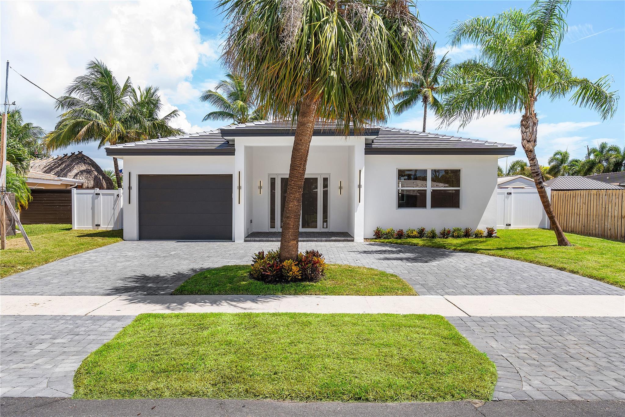 Nestled in the heart of Garden Isles, this new construction waterfront residence offers 50 feet of pristine water frontage with direct Intracoastal access. Thoughtfully designed to balance modern sophistication with inviting warmth, this 3-bedroom, 3-bathroom home is the epitome of effortless coastal living. Step inside to discover light-filled, open-concept living spaces where expansive sliders frame sweeping water views and create a seamless indoor-outdoor flow. At the center of the home, the designer kitchen features custom cabinetry, 10 foot ceilings, and a layout tailored for both daily living and elegant entertaining. This is truly a boater's dream.