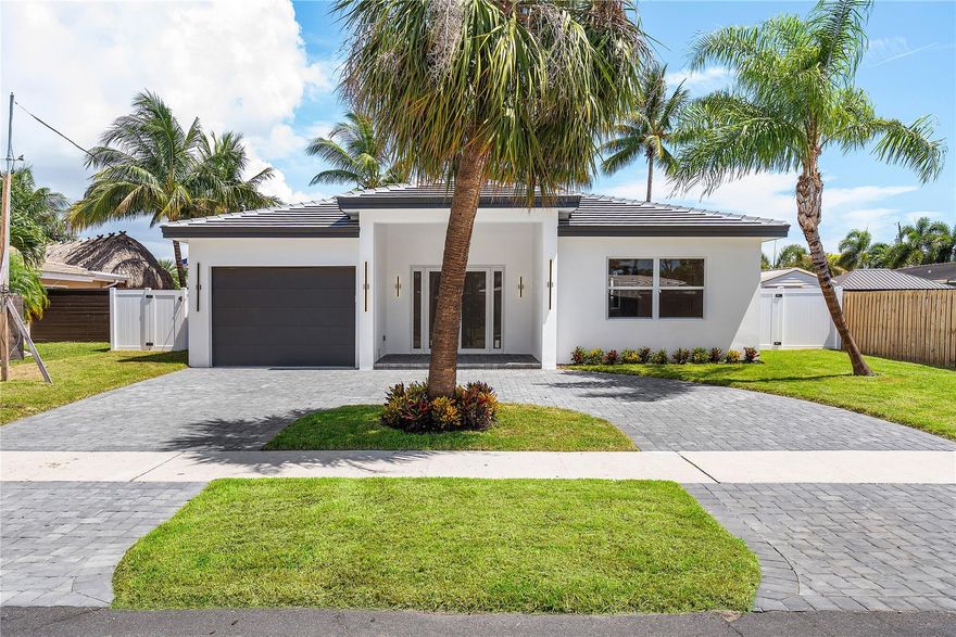 Nestled in the heart of Garden Isles, this new construction waterfront residence offers 50 feet of pristine water frontage with direct Intracoastal access. Thoughtfully designed to balance modern sophistication with inviting warmth, this 3-bedroom, 3-bathroom home is the epitome of effortless coastal living. Step inside to discover light-filled, open-concept living spaces where expansive sliders frame sweeping water views and create a seamless indoor-outdoor flow. At the center of the home, the designer kitchen features custom cabinetry, 10 foot ceilings, and a layout tailored for both daily living and elegant entertaining. This is truly a boater's dream.