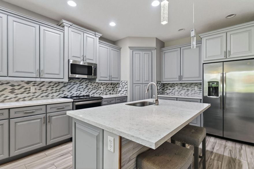 SELLER TO PRE-PAY 1 YEAR OF HOA!!  Enjoy life in this peaceful but active over 55 community. Pristine 3 bed, 2 ½ bath PLUS OFFICE, mudroom, ISLAND kitchen, one-touch custom blinds, neutral paint, TILE floors throughout, TWO master walk-in closets, IMPACT windows and doors, professional garage organizer, screened back patio. Community amenities: 2 heated pools, multi-million$ clubhouse, hot spa, waterpark, basketball, tennis, bocce, billiards, gym, yoga, game room, picnic areas, more! Walk to downtown Tradition, with many festivals, activities and concerts, dozens of upscale neighborhoods with lakes, walking trails, parks, shopping, al fresco DINING, Cleveland Clinic HOSPITAL.  Nearby is GOLF, hiking, BEACHES, nightlife, BOATING, NY METS spring training, much more. PBIA only 50 minutes. Stunning extended kitchen with extra soft-close cabinets, huge quartz center island, hidden full size pantry, dual oven, microwave & dishwasher all GE Profile high-end appliances. Extra floor to ceiling soft-close cabinets in master bathroom.  HOA Includes almost everything! Blue Stream Fiber is your local provider for super-fast Internet, Cable TV, home phone and home security services to the residents of the various Tradition communities, included in your HOA payment. Additionally, lawn mowing, edging, trimming, irrigation \  irrigation system and exterior pest control are all included.  FURNISHED:  Two of the three bedrooms are furnished, plus an office, the eat-in-kitchen dinette set and the living room set, and the wall mounted television are all included in the sale.  Mrs. Clean lived here and the place is spotless.  Bring your clothes and toothbrush and be ready to enjoy the good life in sunny Florida.