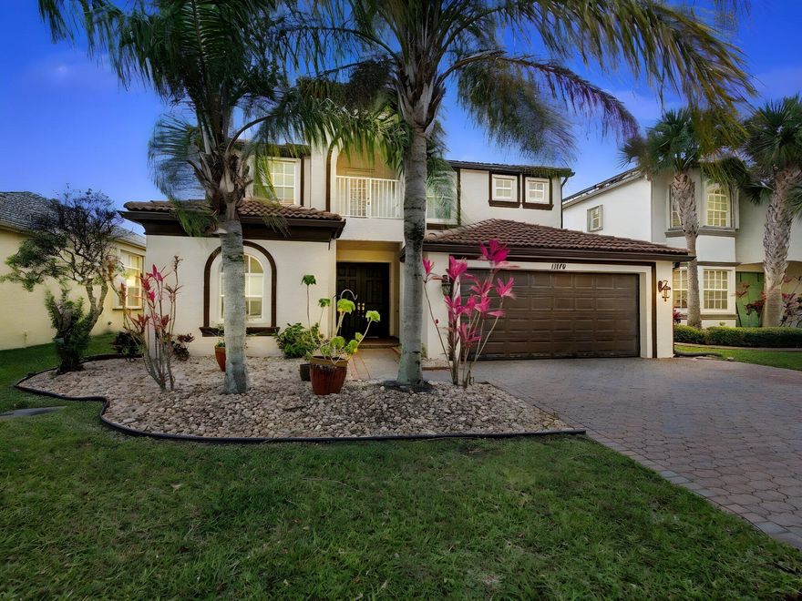 Beautifully maintained 5-bedroom, 3.5-bath, 2-car garage lakefront home in the highly sought-after TownPark community of Tradition. This popular Coventry model is loaded with upgrades, including fully upgraded kitchen and bathroom countertops, redesigned kitchen island cabinetry with widened countertops, double oven, electric induction cooktop, stainless steel appliances, and a whole-house water filtration system. Additional improvements include a microwave vented to the exterior, new water heater (2025), bamboo flooring throughout the upstairs and staircase, custom closets in the primary and two additional bedrooms, and a marble ledger panel accent wall in the family room. The primary and loft bathrooms have been tastefully renovated with frameless glass shower doors, tiled walls, and a jet shower system. A versatile added bedroom and closet upstairs off the primary bedroom provide additional flexibility. Air handlers were replaced in 2015, and the home also includes a brand new washer and dryer. Exterior enhancements include a widened driveway that accommodates up to three cars side-by-side, a French drain system for improved drainage, bordered flower beds, and tranquil lakefront views, creating a peaceful outdoor setting.  This home offers a bright, open-concept floor plan that seamlessly connects the main living areas to a covered patio overlooking the lake—perfect for both everyday living and entertaining. The spacious primary suite is a true retreat, complete with a private sitting area, oversized custom walk-in closet, and a covered balcony with stunning water views.  Enjoy a short walk to the clubhouse, where residents have access to resort-style amenities including a pool, fitness center, tennis, basketball, and more. HOA fee includes cable, high-speed internet, gated security, recreational facilities, alarm monitoring, and landline phone. Located in the heart of Tradition, this move-in ready home combines luxury upgrades, functional living space, and an unbeatable community lifestyle.