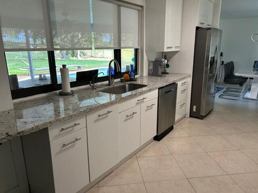 Come see this stunning, updated 4-bedroom, 3-bathroom corner-lot home in the heart of Davie. Designed with an open and inviting layout, this home seamlessly flows into a gorgeous patio and sparkling saltwater pool—perfect for relaxing or entertaining. Enjoy peaceful golf course views right from your backyard, creating a serene setting to unwind day or night. Whether you're hosting guests or enjoying a quiet evening, this home offers the ideal backdrop. Additional highlights include: Impact windows and doors for added safety and efficiency, spacious layout, private in-law suite with its own entrance and kitchenette—ideal for guests or extended family. This home truly feels like a vacation every day. Some furniture is negotiable. Available for move-in May 1st. Range/oven will be replaced prior to renting.  Showings will start April 13th.