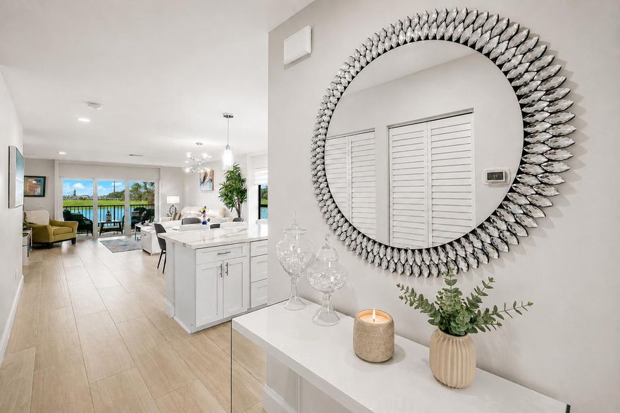 Bright, sunny, and beautifully renovated, this 2BR/2BA corner condo offers some of the most spectacular views in Hunters Run Country Club — expansive east-facing double lake and golf course vistas that create a stunning backdrop from sunrise onward. Located on the 2nd fl and just a short walk to the main clubhouse. Renovated throughout w/ wood-look tile flooring, custom lighting, all new interior doors, custom-fitted closets, and full-coverage hurricane impact windows, sliders & front door. The bright white kitchen features wood cabinetry, double-thick quartz countertops, glass backsplash, a custom desk area, breakfast bar seating, and 3-year-old appliances. Thoughtfully designed, the condo offers a clean, contemporary feel. A truly move-in ready offering with exceptional style and views. Located in Hunters Run Country Club, a premier, private, gated community offering a true resort lifestyle. Residents enjoy 54 holes of championship golf, an expansive racquet sports program with tennis and pickleball, and a state-of-the-art fitness center with classes and wellness services. The community features multiple full-service dining venues, a resort-style pool , three bars including poolside, and a vibrant calendar of social events, clubs, and activities — all within a beautifully landscaped setting. Just a short drive to vibrant downtown Delray Beach, with its renowned restaurants, boutiques, and coastal charm.