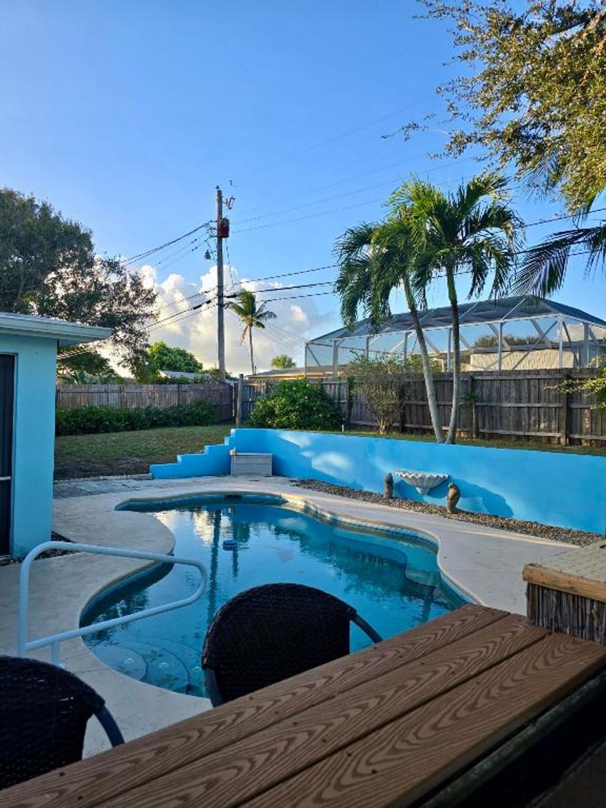 Welcome to this inviting 2BR/2BA Jensen Beach pool home offering the perfect blend of comfort and coastal living. The home features a spacious family/bonus room ideal for entertaining, a home office, or additional living space. Updates within the last 10 years include the kitchen, A/C, roof, bathroom, and septic drainage field. Newer laminate flooring enhances the living room and bedrooms, while stone flooring flows through the dining area, kitchen, and family room. Storm protection shutters. Step outside to your private backyard oasis with a screened-in patio, sparkling pool, and outdoor bar area—perfect for enjoying Florida living year-round. Conveniently located near beaches, shopping, dining, and all that Jensen Beach has to offer. Open House January 30th & 31st from 12-2 PM.