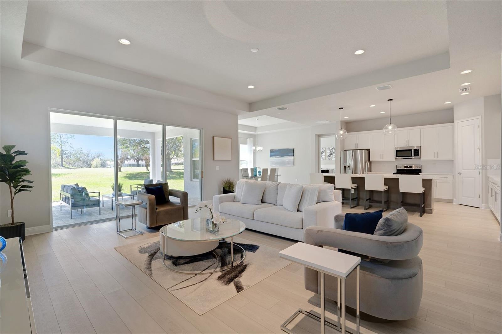 Live the country club lifestyle in this 2022 custom home in Lake Jovita Golf and Country Club. Inside, triple tray ceilings, elegant lighting, and a 10-ft quartz island anchor the gourmet kitchen with 2023 stainless appliances, soft-close wood cabinetry, and under-cabinet lighting. The open living room offers LED accents and triple sliders framing stunning golf course views. A triple split floor plan offers space and privacy, with a serene primary suite, picture window overlooking the fairway, spa-like bath, and custom closet. Enjoy sunsets on the extended patio and a 3-car garage with Sparc Tek floors, storage, and EV charger. No detail was overlooked, all in a guard-gated community with top-tier amenities for a low HOA.