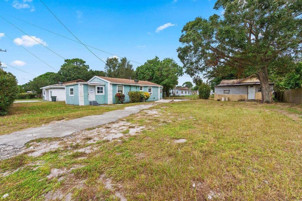 TWO HOUSES FOR THE PRICE OF ONE!! The main home is 3 bedroom, 1 bath. The second home is a 2 bedroom, one bathroom. The second home needs a lot of work. Fenced in yard in back of main home with mature mango trees. Perfect separation between the two homes for tenants. Great income potential for two homes on one parcel!