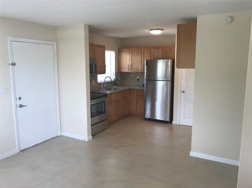 Remodeled interior East Side 2 bedroom 1 bath Condo. Newly installed Bathroom, kitchen with granite counter top, complete new  tile throughout, new AC unit, New Water Heater, brand new stainless steel appliances, and freshly painted. All work done legally permitted. 10 min from Lauderdale By the Sea. Great investment, can be rented immediately, no 12 month wait. there is a tenant in there now paying $1150 a month, they should be out by January or sooner. Property has Tennis Courts, Pool, Racket Ball Courts, Gym and BBQ Area.Price is Negotiable $$