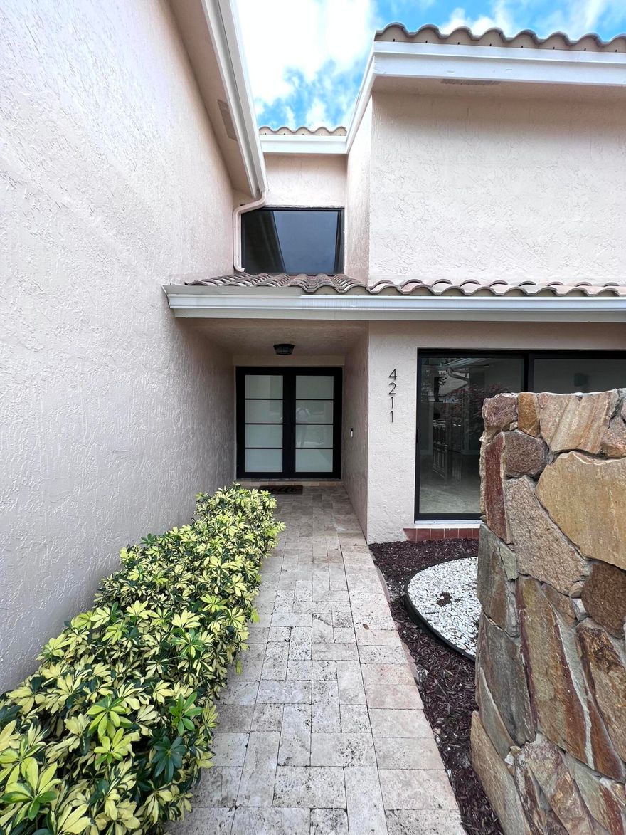 Tucked away in the highly-sought out community of Colonnade, this 4 bed 3 bath Pool/lakefront Home will not last long! Sprawling over .4 acre, this cul de sac property offers over 3,300sqft of living space featuring marble floors, vaulted ceilings, endless natural light, travertine pool-deck, stone fireplace, very open and spacious 2006 Roof, updated appliances and Kitchen + 2 new A/C units (both 2018) and impact glass throughout.  The perfect spot for entertaining, this house is sure to impress! Parking will never be a concern with with your travertine tiled driveway providing room for at least 5 cars + a 2-car garage.  tennis and basketball courts within the community.