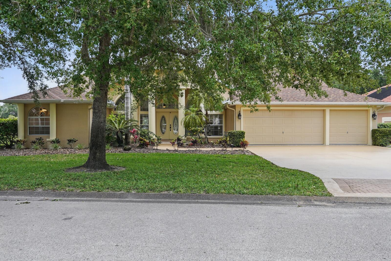 Welcome to 47 Old Oak Drive South, located in the desirable gated community of The Sanctuary at Palm Coast. This meticulously maintained 3-bedroom plus office, 2-bathroom home offers 2,487 sq. ft. of living space, providing plenty of room for comfortable living and entertaining. The open floor plan features abundant natural light and a cozy living room with a fireplace, perfect for relaxing on cooler evenings. The gourmet kitchen includes a spacious island, stone countertops, and solid wood cabinets, ideal for meal preparation and hosting gatherings. Step outside to your private backyard oasis, where you can enjoy a heated pool overlooking a tranquil pond with a soothing fountain. The outdoor space is perfect for both relaxation and entertaining.