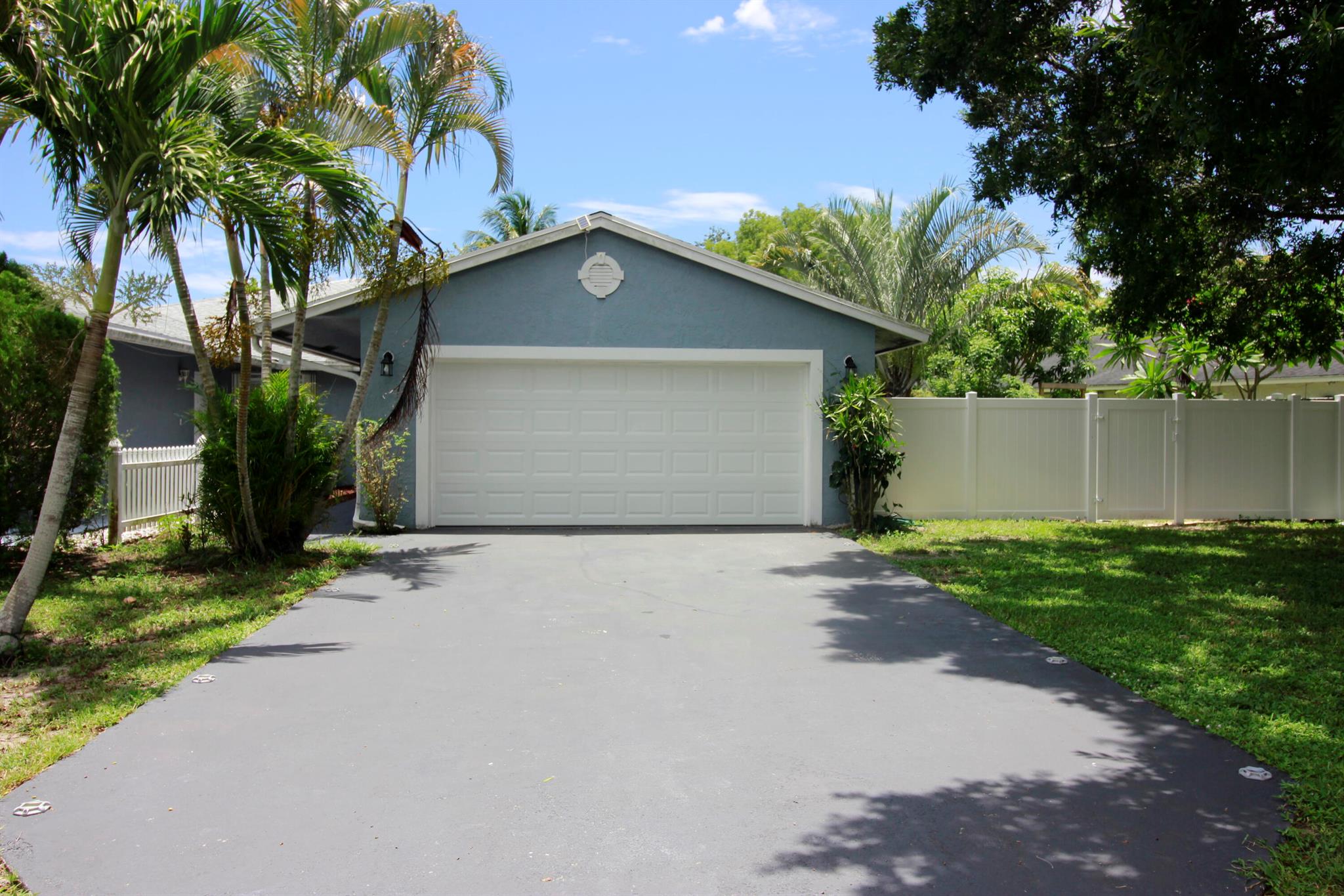 Rare opportunity to rent a 3BR/2BA single-family style villa with a 2-car garage in the heart of Royal Palm Beach! This beautifully maintained home offers stunning curb appeal with a shade tree in the front yard and a huge driveway. The fully fenced backyard backs directly to a peaceful canal perfect for grilling, entertaining, or simply relaxing in your own outdoor retreat. Inside, you'll find gorgeous hardwood floors, updated light fixtures, and a modern kitchen with shining stainless steel appliances. Both bathrooms have been tastefully renovated, and there's a separate utility/laundry room for added convenience. No HOA means fast approval and fewer hassles! Located close to parks, shopping, and places of worship--this home offers the perfect blend of comfort, location, and lifestyle.
