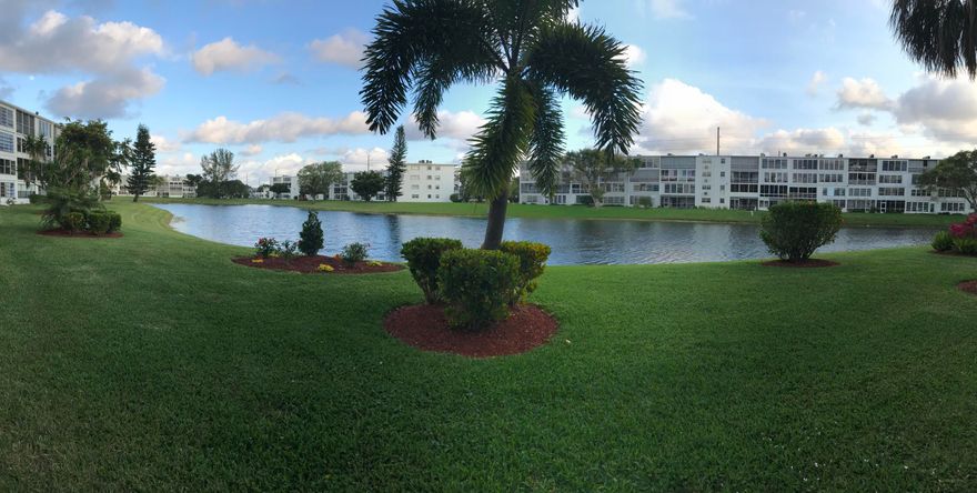 Ground floor unit overlooking lake & gardens from sun room. Bathroom has been fully remodelled including tu/shower walls and sink. Sunroom has newer style windows and floor to ceiling sun shades. Unit is being sold completely furnished. Well cared for unit includes transferrable ''Pride'' service contract on all appliances and A/C. convenient parking. Community offers 65,000 sq' clubhouse with 1500 seat theater offering live shows and movies, fitness center, art rooms and classes, clubs for many interests, Courtesy bus service, Billiards, tennis, pickle ball, shuffleboard and more. 4 miles from beach.