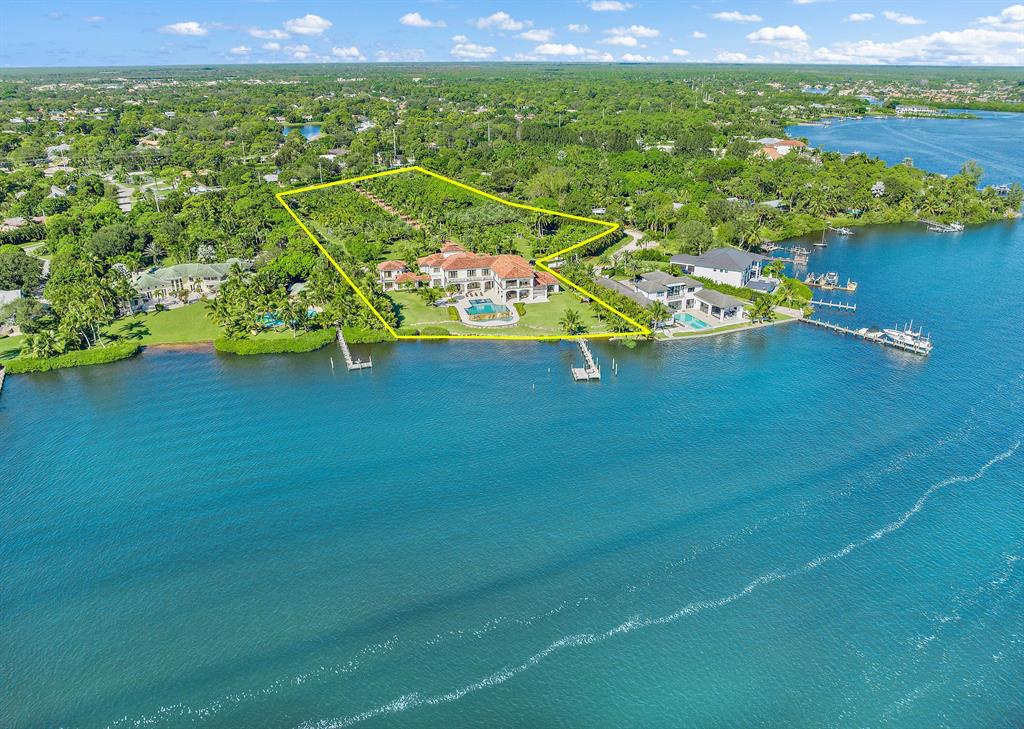 EXQUISITE OPPORTUNITY to Own the Largest Assemblage of Waterfront Land available in JUPITER! This legacy property boasts a majestic 6.25 Acres with 254' of wide water frontage. Offering the Ultimate in Privacy + Security, this modern palazzo boasts an imposing 18,302 sq. ft. A gated 640' palm treed drive leads to this stunning abode. Masterfully built in 2016 by award winning Anderson Moore using only the finest materials, this home features full Control 4 automation. Interiors include a soaring 2 story entry, stunning wood + marble floors + mouldings, creating a magical ambiance. Finely curated furnishings provide an exquisite move in ready haven. The hub of the home is the grand kitchen and family room, an elegant oasis of luxury + comfort. The professional ASID award winning kitchen