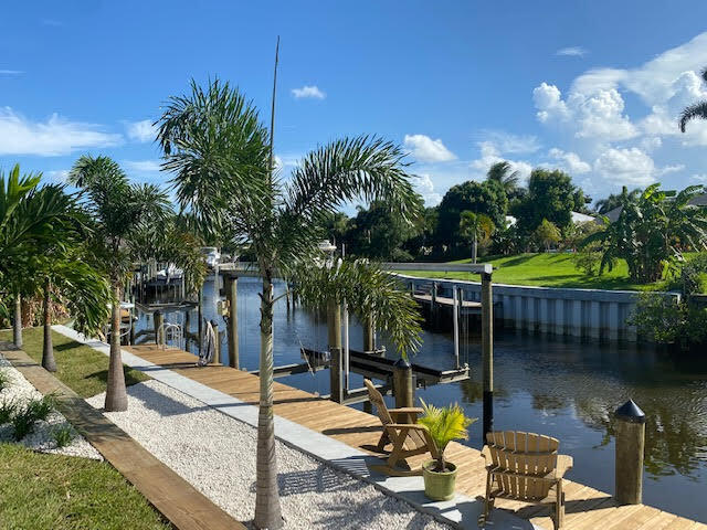 Rare Opportunity! Boaters Dream home! New seawall, doc and boat lift in your back yard! (Expected to be completed in Aug) 3 bed 3 bath plus a Den! One bedroom is included as an in-law suite, additional den and kitchenette. 20 Minutes to the river and 30 min to the ocean. Not to mention the Florida room and open floor concept. This home is almost completely remodeled, energy efficient with a New roof and AC! Very popular Palm city area, quiet community with the park and dog park near by! The boat lift holds up to 10,000lb with a boat ramp just feet away. All this is just waiting for someone who will take great care of it. Is this what you've been waiting for? Don't miss this Rare opportunity!