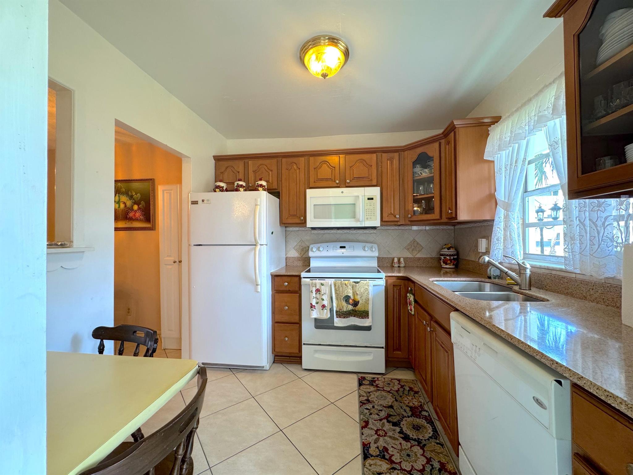 Florida Retirement or Vacation home. Welcome to this charming **2-bedroom, 1.5-bathroom condo** in a highly desirable **55+ private gated community in Hollywood, FL**. Perfectly situated on the **first floor**, this residence offers convenience, comfort, and updated finishes throughout.Step inside to find a **bright and inviting space** with **sleek tile flooring**. The updated **kitchen boasts stainless steel appliances, wood cabinetry, and granite countertops**, opening into a spacious living area. Both bathrooms have been thoughtfully updated. First floor unitFully updated kitchen & bathsNew AC & tankless water heaterPartial impact windows (rear)Community pools & clubhouseFlexible furnishings (partially furnished / unfurnished options)
