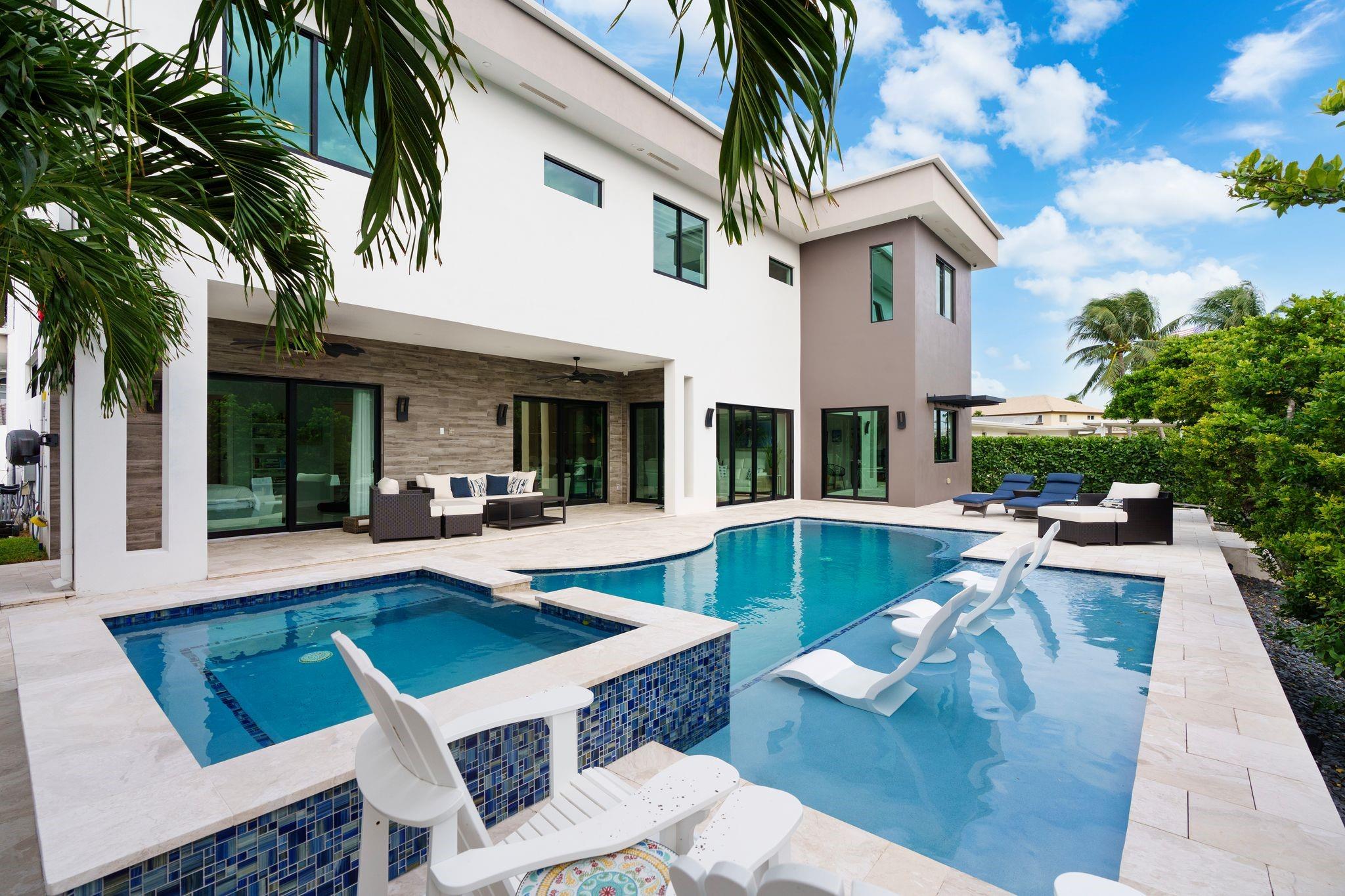 Welcome to this recently completed residence in prestigious Lighthouse Point! Inside, you will find 5 spacious bedrooms with built out closets & 5 nicely appointed bathrooms along with upstairs & downstairs laundry spread over 4,200+ square feet. An imported Italian Kitchen is the focal point downstairs with its oversized island & Thermador appliances. The open living space transitions seamlessly to the outdoor space really making this home an entertainer's dream! Custom upgrades galore including smart shades, indoor & outdoor speakers, cameras/security system, summer kitchen, whole house generator & ceiling mount racks in garage for storage. For boaters, the home is situated on 80’ of deep water, complete w/ 15k lb boat lift & jet ski dock & just 15 minutes to the Hillsboro Inlet.